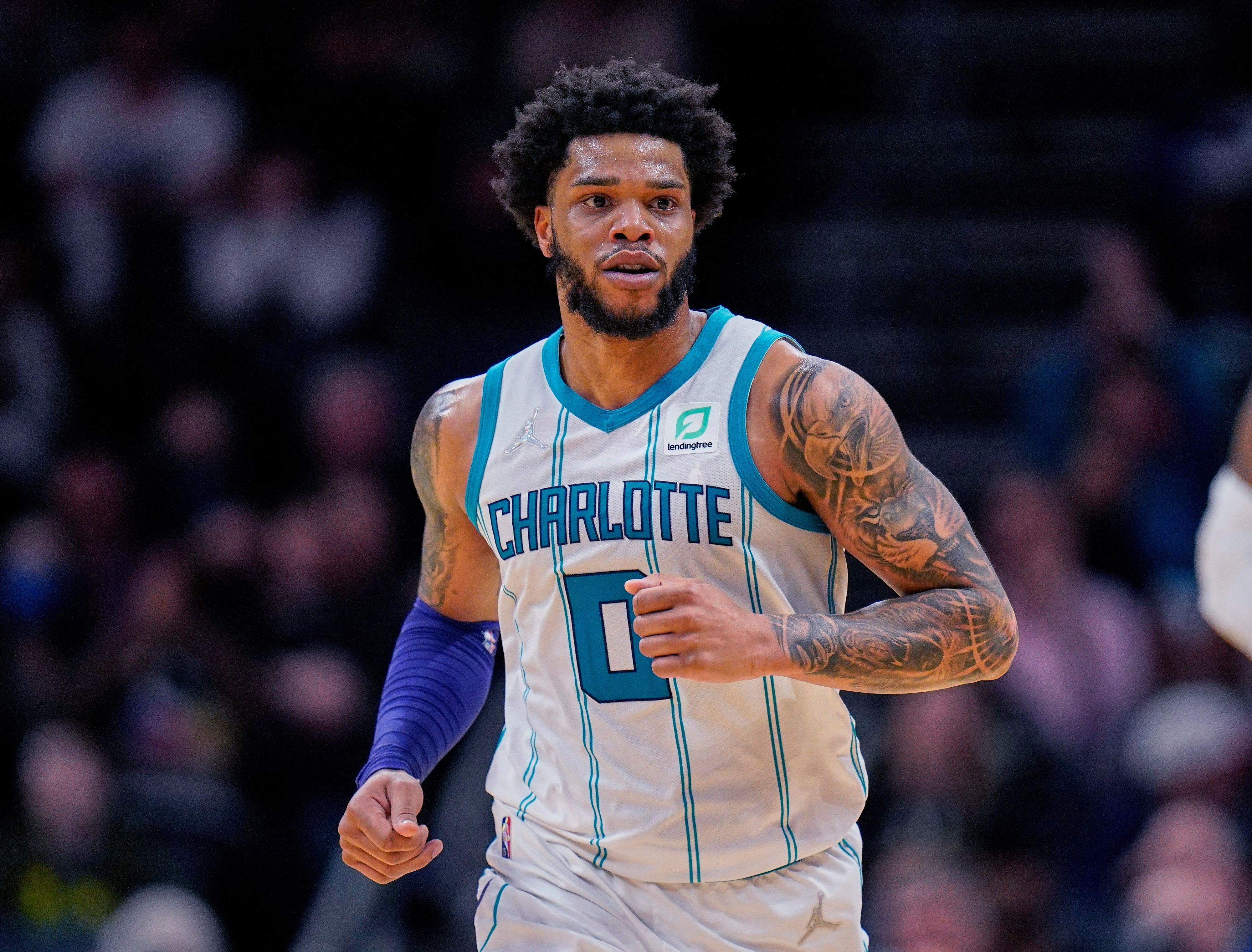 FILE - Charlotte Hornets forward Miles Bridges moves upcourt during the team's NBA basketball game against the Denver Nuggets, March 28, 2022, in Charlotte, N.C. The Charlotte Mecklenburg County Sheriff’s Office says it has an unserved warrant for Bridges for a violation of a domestic violence protective order along with an unserved criminal summons for a domestic protective order violation, misdemeanor child abuse and injury to personal property. The sheriff’s office said the warrant was issued in January and the criminal summons was issued Wednesday, Oct. 11. (AP Photo/Rusty Jones, File)