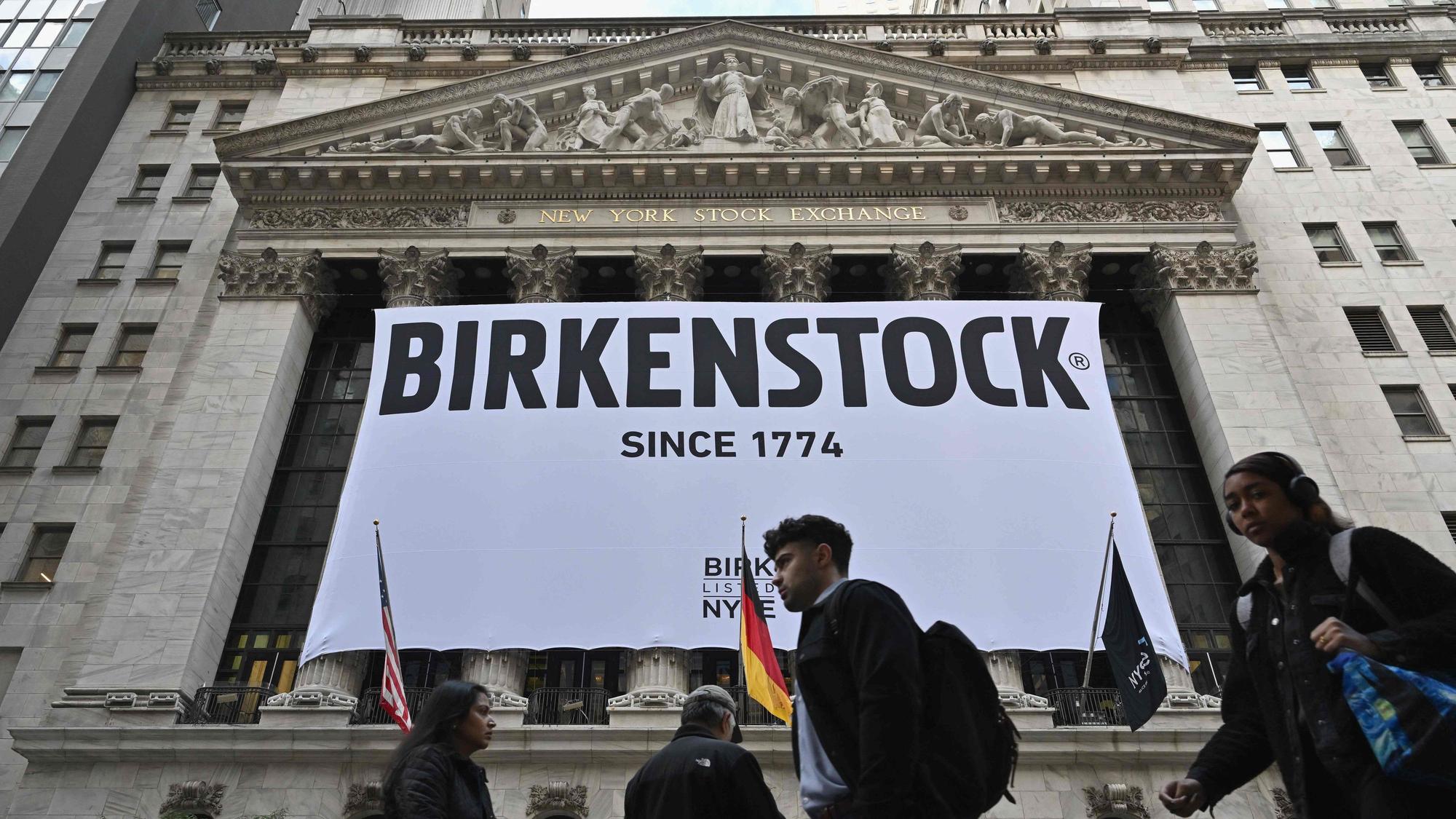 TOPSHOT - A Birkenstock banner hangs outside the New York Stock Exchange (NYSE) in New York on October 11, 2023, as Birkenstock launches an Initial Public Offering (IPO). German sandals maker Birkenstock has set its share price at $46, the firm said in a press release early Wednesday. A total of 32.26 million ordinary shares will be offered in its initial public offering, trading under the symbol BIRK. (Photo by ANGELA WEISS / AFP)