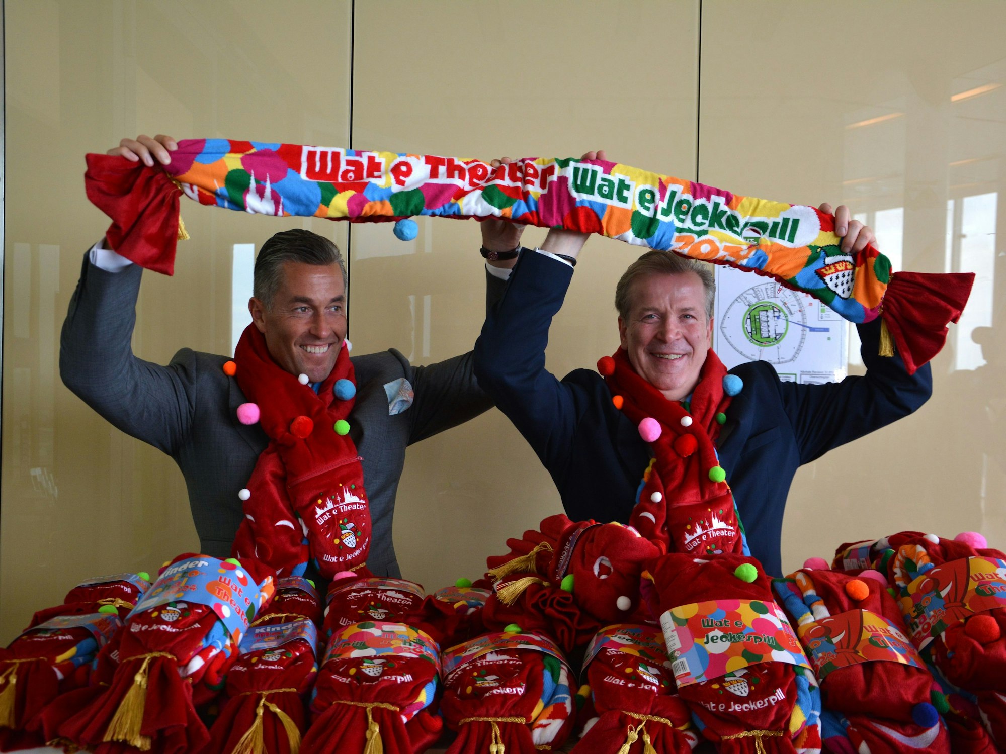 Kuckelkorn und Geiss halten den Schal hoch.