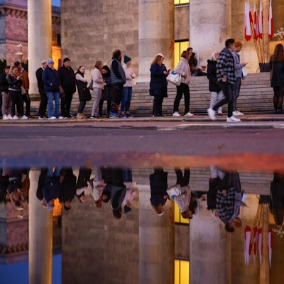 15.10.2023, Polen, Warschau: Menschen warten in einer Schlange, um ihre Stimme während der Parlamentswahlen abzugeben. Bei der Parlamentswahl in Polen hat sich eine starke Beteiligung abgezeichnet. Foto: Michal Dyjuk/AP/dpa +++ dpa-Bildfunk +++