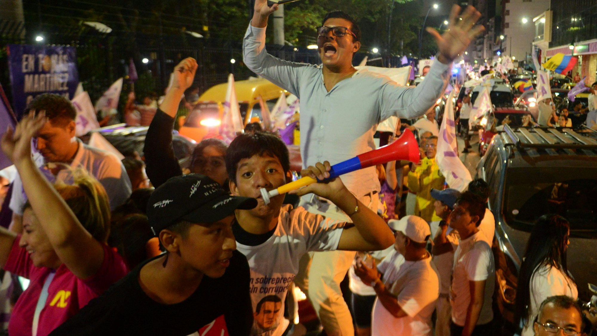 Supporters of Ecuador's presidential candidate for the National Democratic Action Party, Daniel Noboa, celebrates after learning the first results of the presidential runoff election in Guayaquil, Ecuador, on October 15, 2023. Polls closed in Ecuador Sunday with no reports of violence as both presidential candidates cast their votes in bulletproof vests just weeks after a rival was murdered. The finalists in the runoff election -- lawyer Luisa Gonzalez, 45, and banana empire heir Daniel Noboa, 35 -- are vying to govern a country in the midst of a drug war and a rash of political assassinations. (Photo by Gerardo MENOSCAL / AFP)
