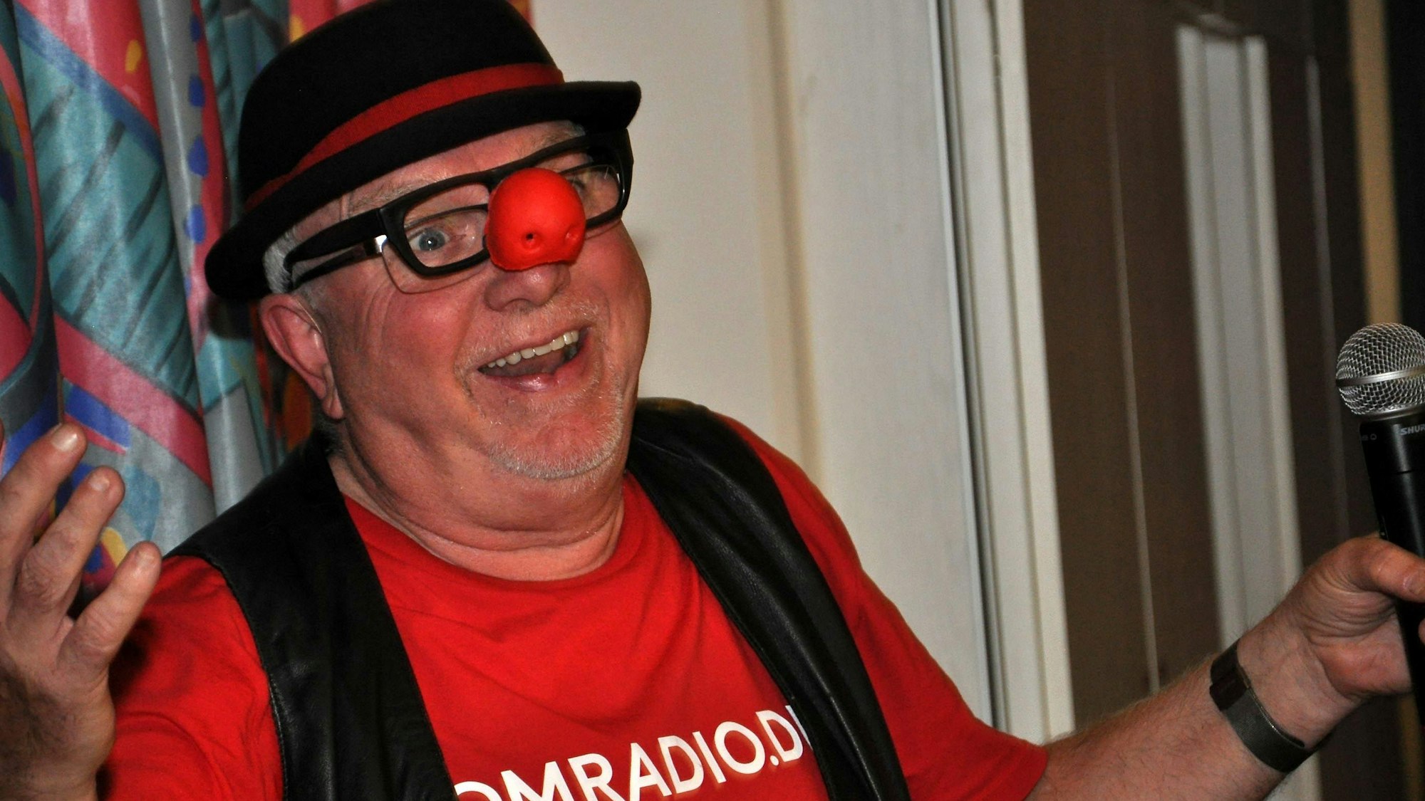 Der Büttenredner Willibert Pauels mit roter Clownsnase bei einem Auftritt.