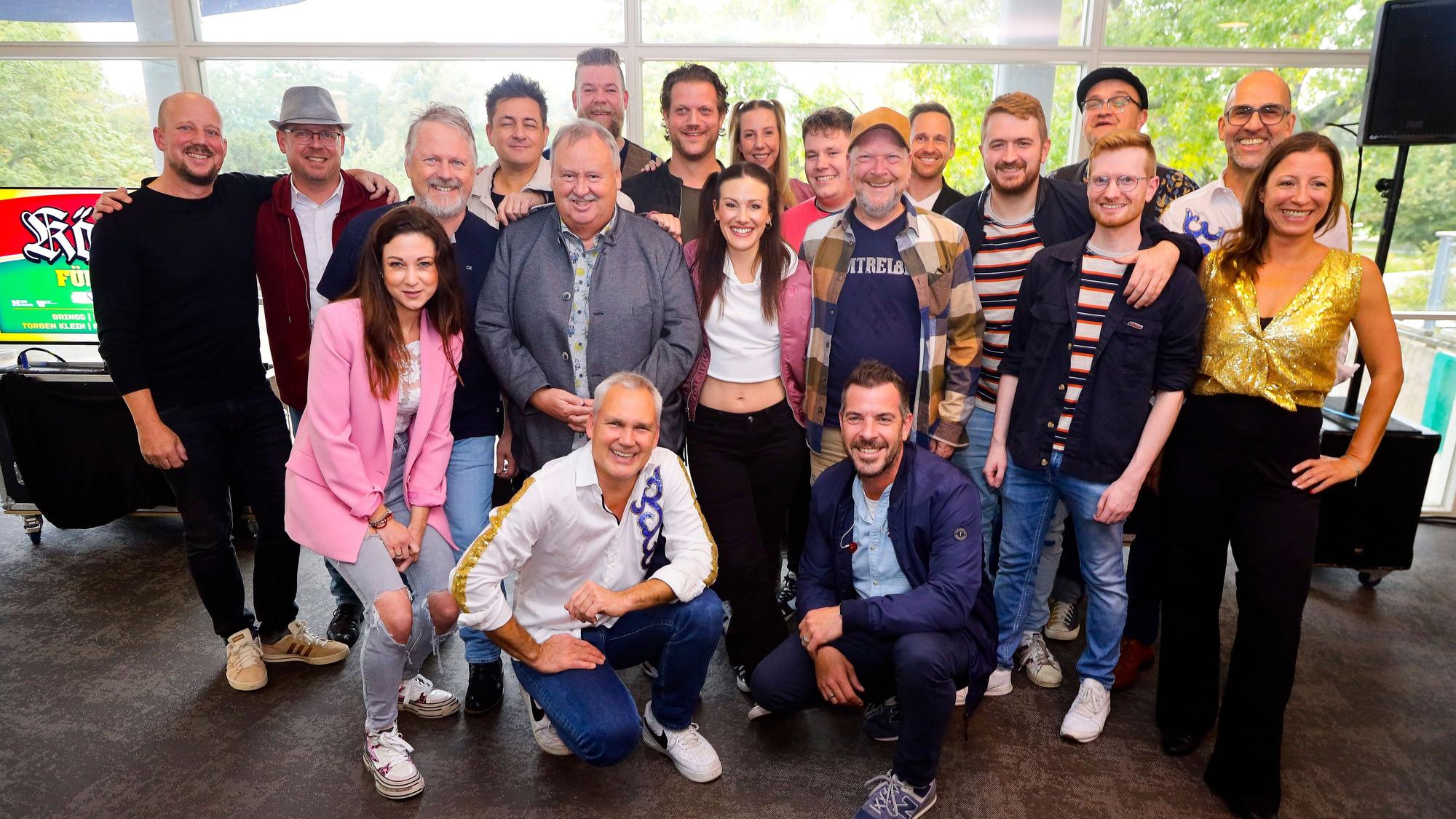 Mehrere Künstler posieren für ein Foto.