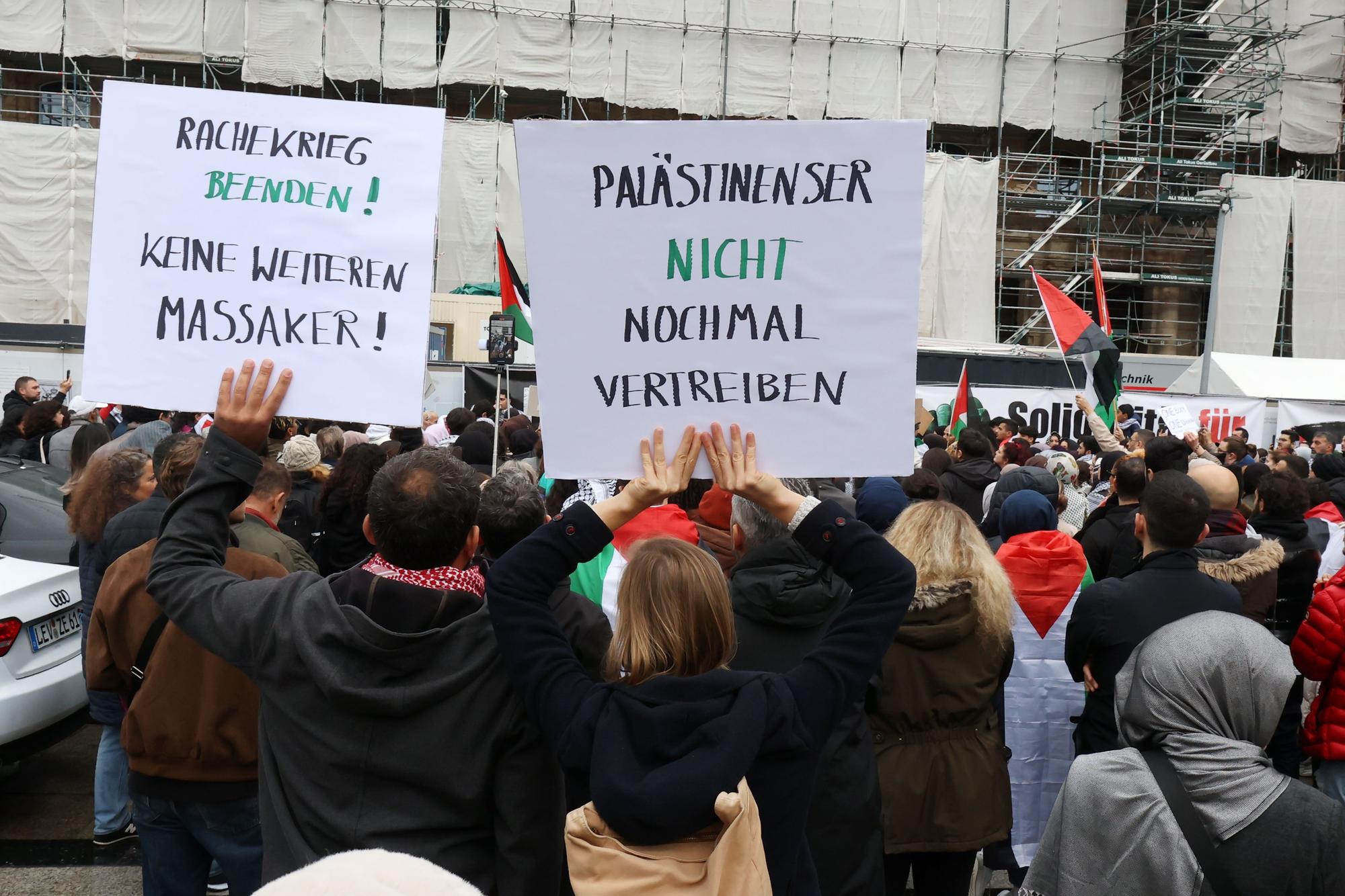 Menschen von hinten mit Plakaten.