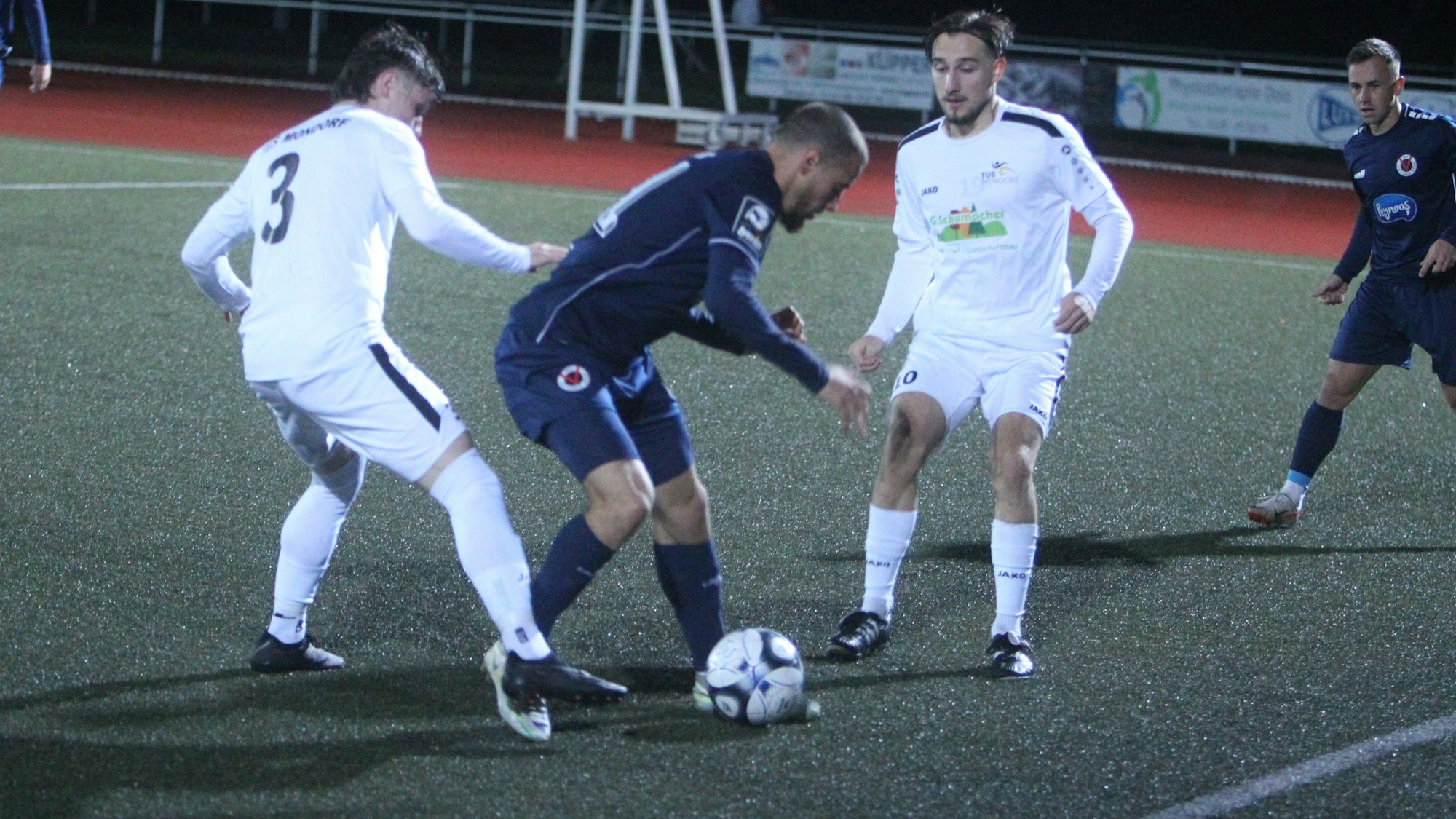 Mondorfs Kilian Schmid (links) stoppt hier den ehemaligen Hennefer Suheyel Najar mit einem Foul. Finn Geiger schaut zu.