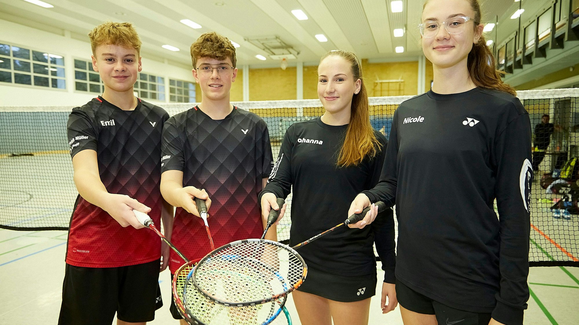 Die Kaller-Badmintonspieler Emil Berg, Mattis Kuhlmann, Johanna Pütz und Nicole Bauer halten ihre Badmintonschläger übereinander.