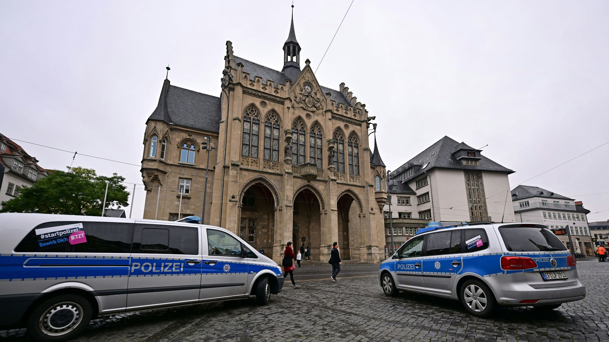 Polizeifahrzeuge stehen nach einer Bombendrohung vor dem Erfurter Rathaus.