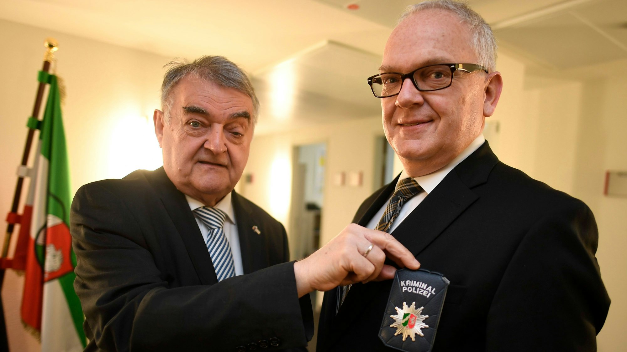 NRW-Innenminister Herbert Reul präsentiert im April 2022 mit Landeskriminaldirektor Johannes Hermanns die neue Polizeidienstmarke, mit der sich Kriminalbeamte ausweisen.