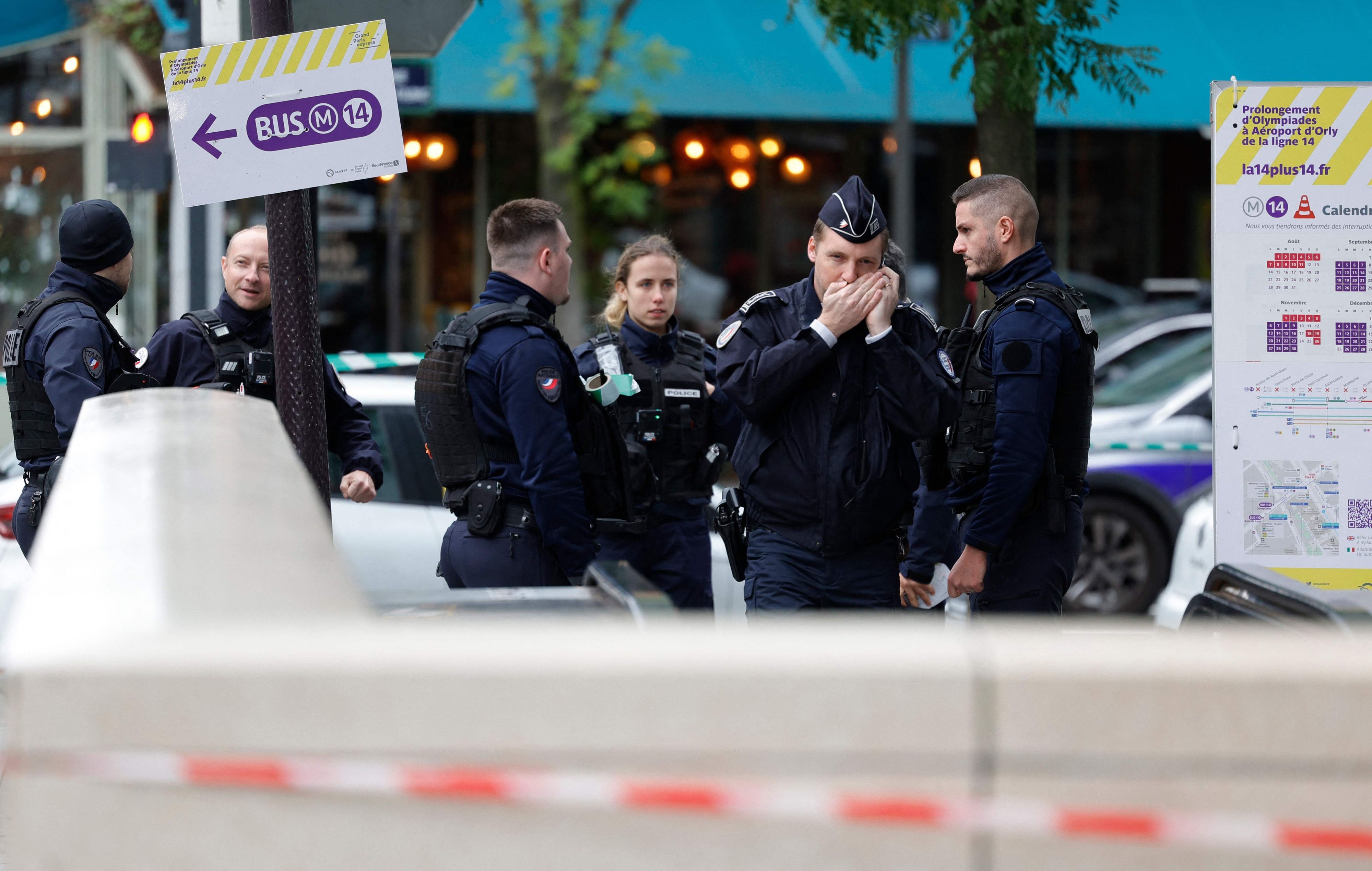 French police officers stand at the entrance of a metro station after a woman making threats on an RER train was shot and wounded by police, in Paris on October 31, 2023. (Photo by Geoffroy VAN DER HASSELT / AFP)