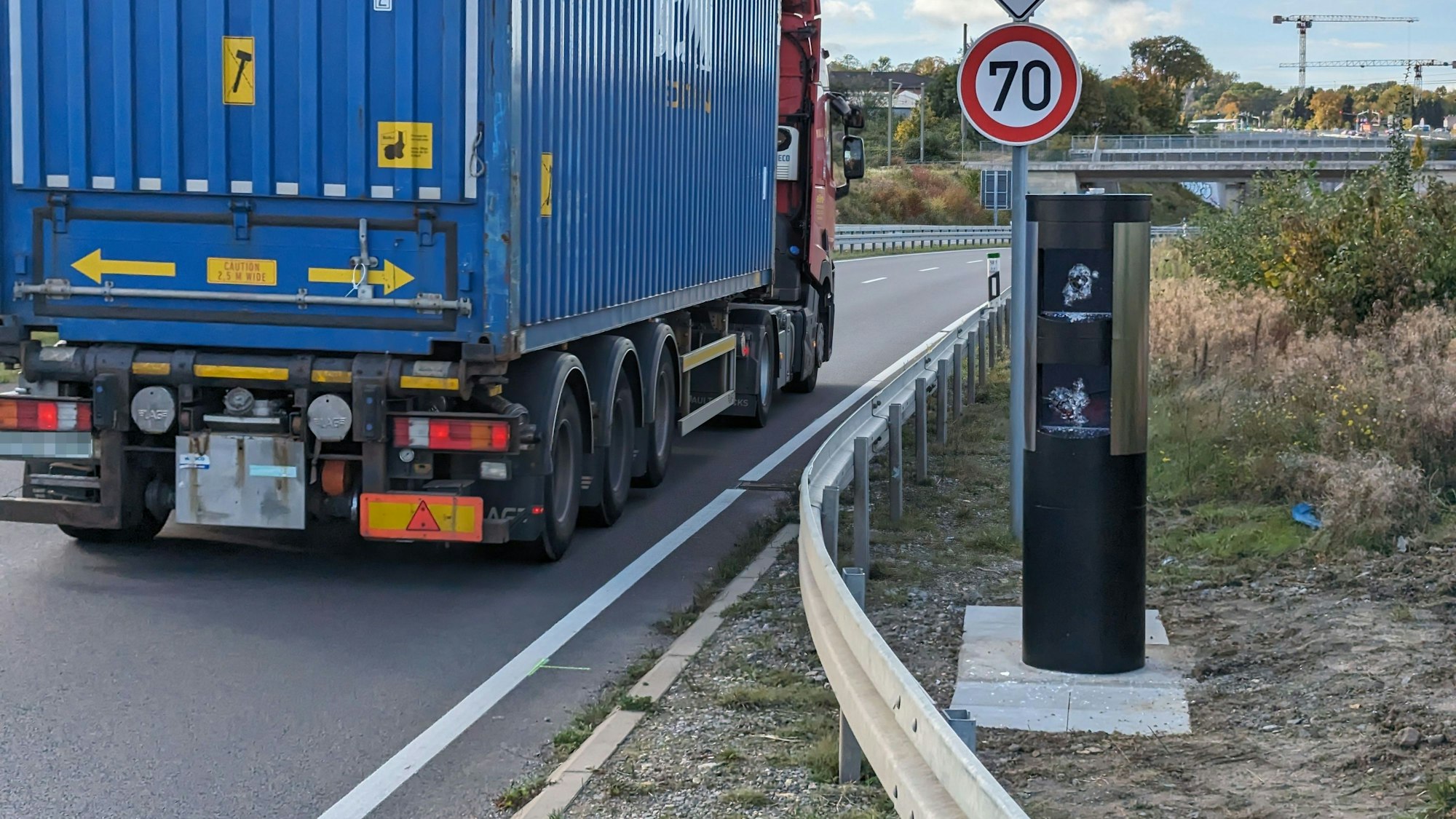 Das Foto zeigt die demolierte Lasermessanlage in Hürth. Ein Lkw passiert die Stelle.