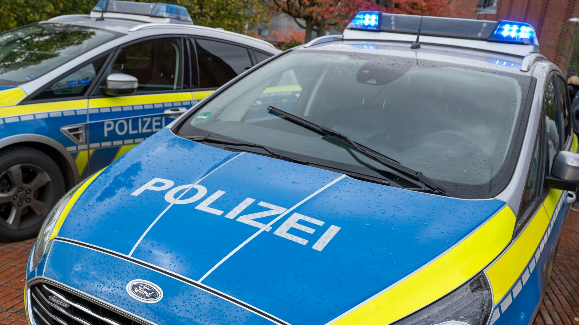 Zu sehen sind zwei Einsatzfahrzeuge der Kölner Polizei in der Vorderansicht.