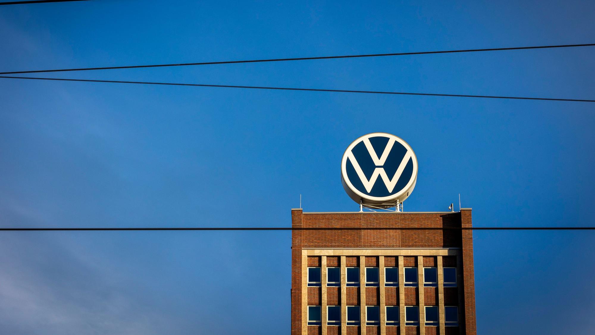 ARCHIV - 28.09.2023, Niedersachsen, Wolfsburg: Das Markenhochhaus im Volkswagen Stammwerk ist am Morgen hinter Leitungen einer Bahnstrecke zu sehen. Volkswagen gibt am 26.10.2023 Zahlen für das 3. Quartal bekannt. Foto: Moritz Frankenberg/dpa +++ dpa-Bildfunk +++