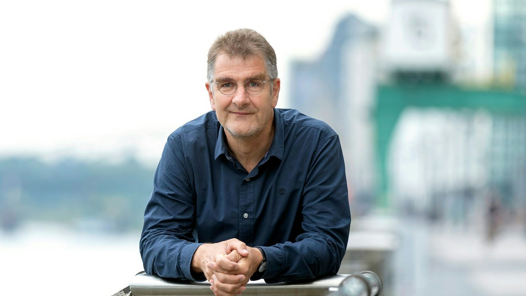 Jürgen Wiebicke lehnt sich auf ein Geländer und guckt in die Kamera.