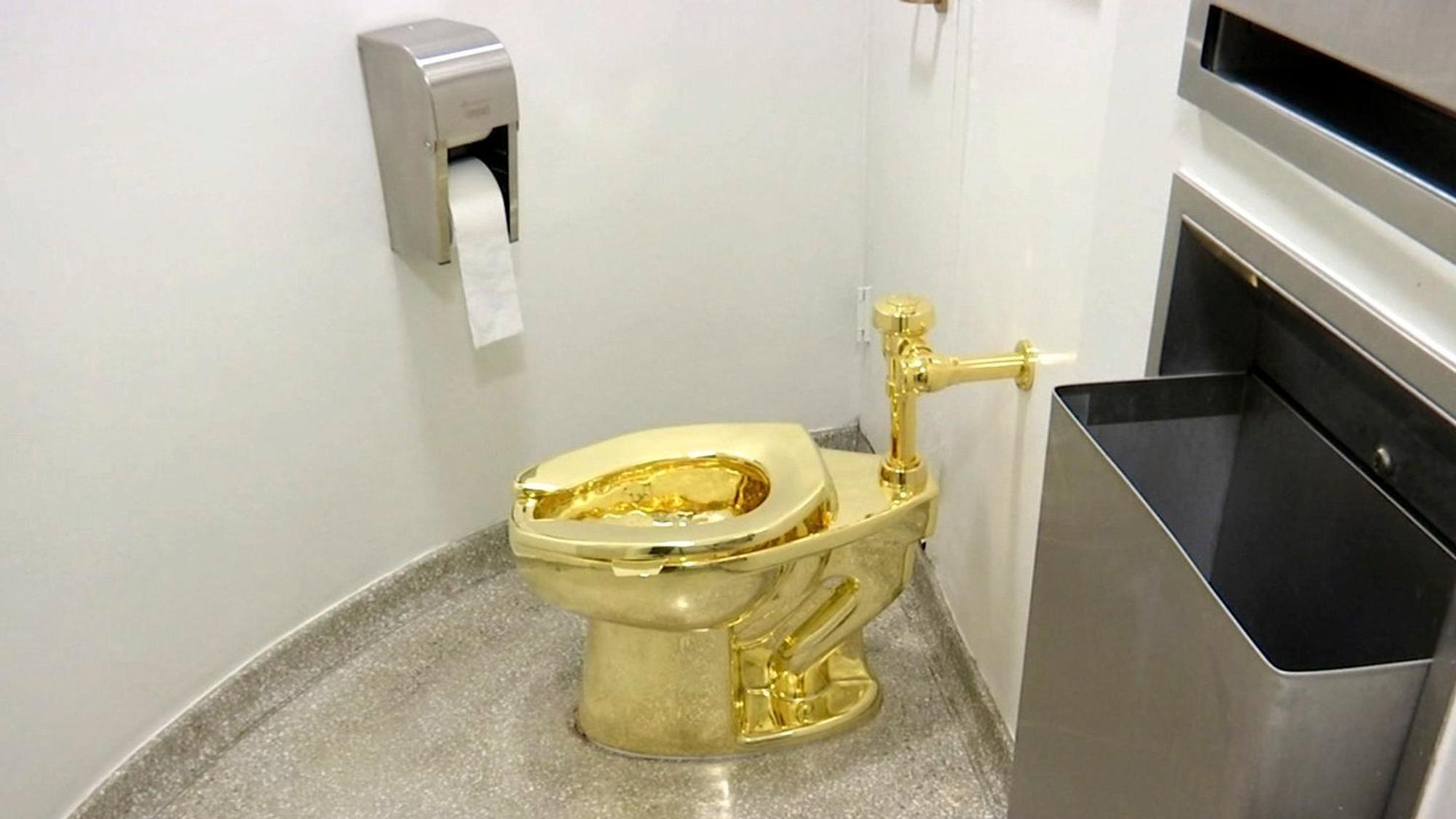 ARCHIV - 16.09.2016, USA, New York: Dieses Archiv-Video-Standbild zeigt eine 18-karätige goldene Toilette «America» des italienischen Künstlers Maurizio Cattelan, die in den Jahren 2016/2017 im Solomon R. Guggenheim Museum ausgestellt war. Die Toilette war 2019 teil einer Ausstellung im britischen Blenheim-Palast und ist dort gestohlen worden. Gut vier Jahre nach dem Diebstahl der goldenen Toilette aus dem britischen Blenheim-Palast sind vier nun Männer angeklagt worden. Sie sollen am 28. November vor Gericht erscheinen. (zu dpa "Vier Männer wegen Diebstahls eines Gold-Klos in England angeklagt") Foto: -/AP/dpa +++ dpa-Bildfunk +++