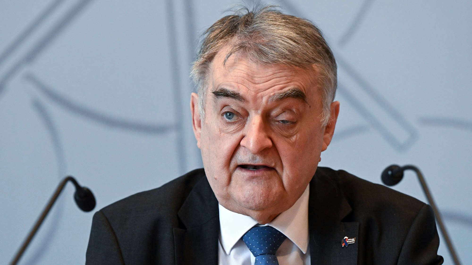 Herbert Reul (CDU), Innenminister von Nordrhein-Westfalen, spricht während einer Pressekonferenz in zwei Mikrofone.