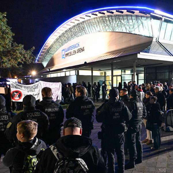 Solo-Konzert von Till Lindemann in Leipzig: Polizisten blicken auf den Gegenprotest, der sich gegen den Rammstein-Sänger stellt.