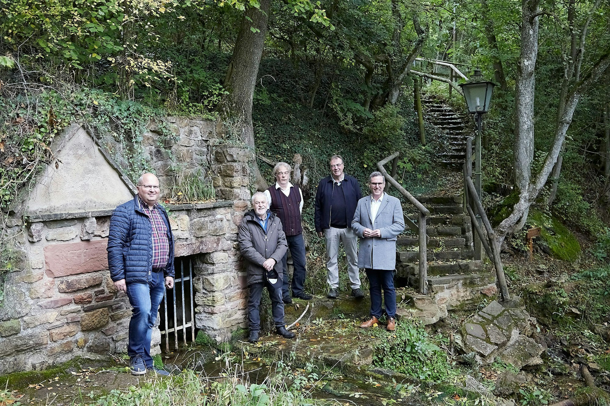 Stefan Stoff, Josef Falkenberg, Dirk Lüderwaldt, Wilfried Pracht und Norbert Crump stehen an der Erftquelle in Nettersheim.