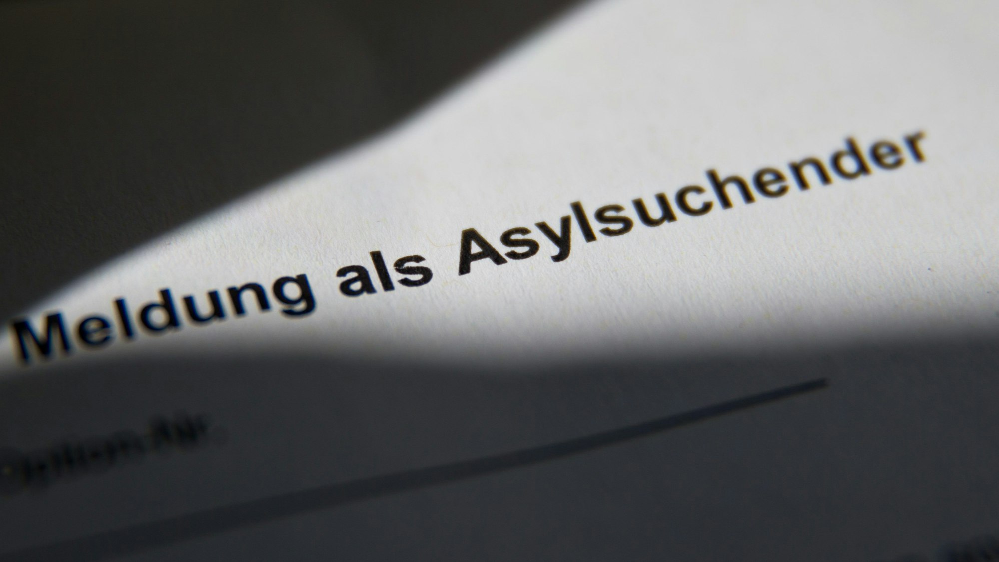 ARCHIV - 17.07.2014, Bayern, Zirndorf: «Meldung als Asylsuchender» ist in der Zentralen Aufnahmeeinrichtung für Asylbewerber (ZAE) auf einer Meldebescheinigung für Asylsuchende zu lesen. (Illustration zu dpa «UNHCR hält Asylverfahren in Drittstaaten mit Leitplanken für möglich") Foto: Daniel Karmann/dpa +++ dpa-Bildfunk +++