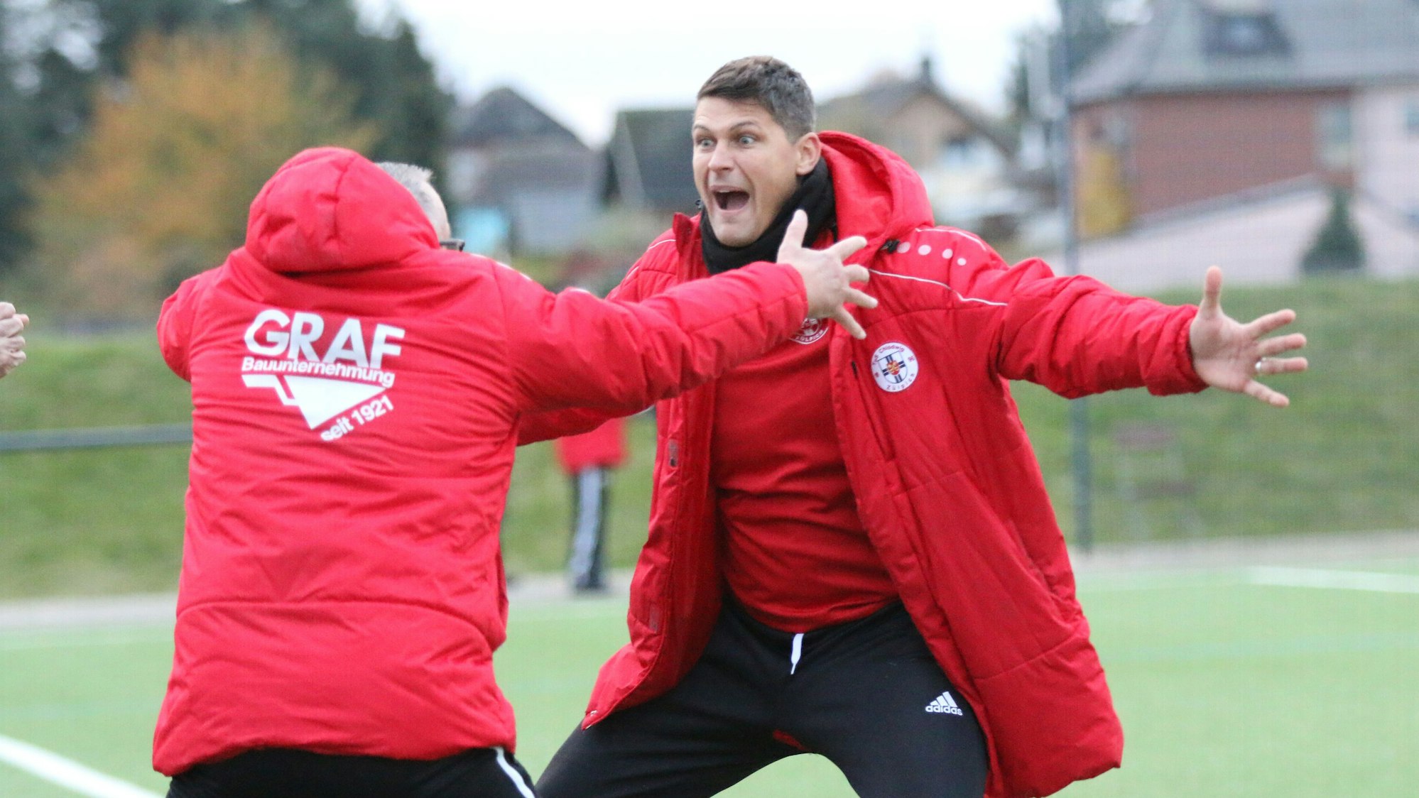 Zülpichs Coach David Sasse und sein Co-Trainer Frank Müller feiern mit ausgestreckten Armen den Treffer zum 2:0 gegen den SC Elsdorf.