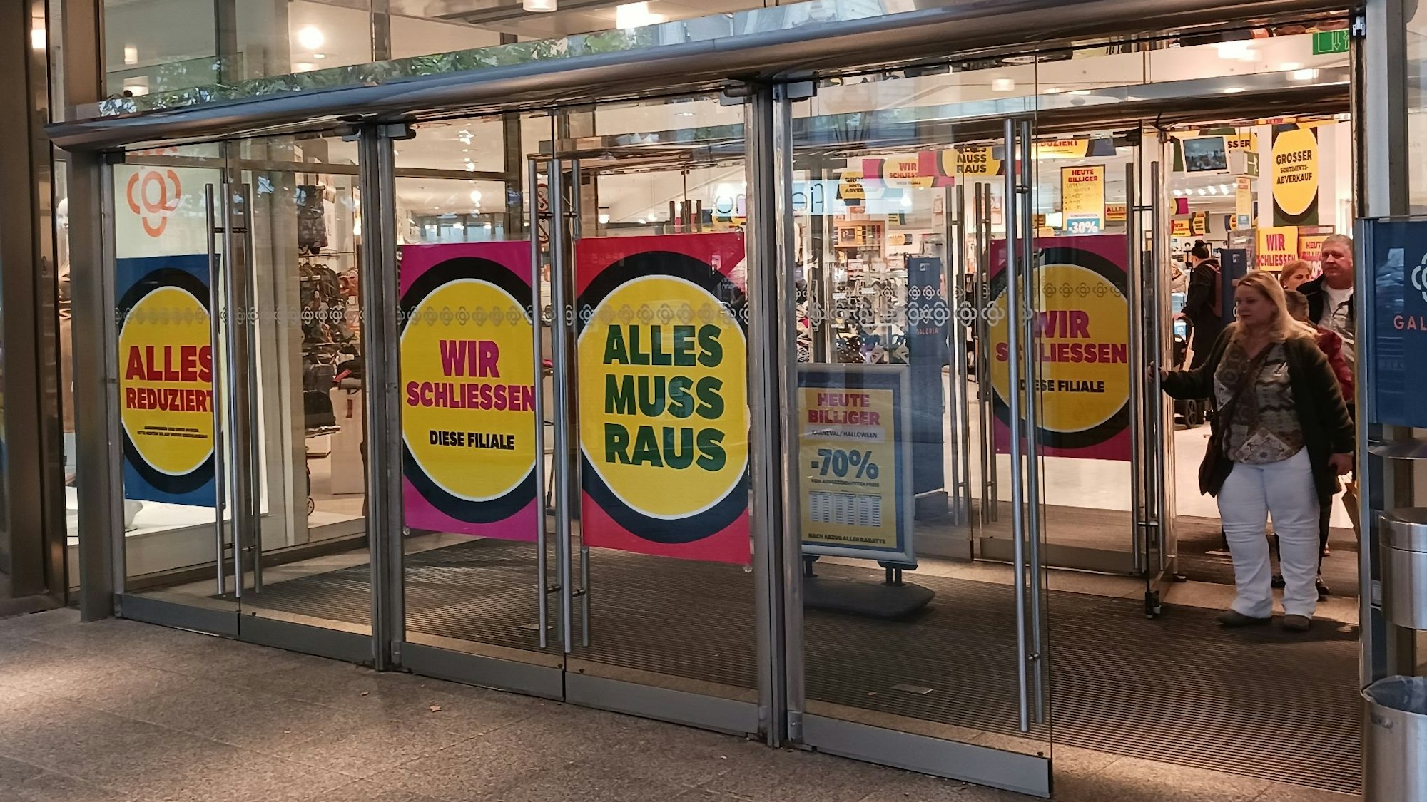 „Alles reduziert“, „Alles muss raus“, „Wir schließen“  steht auf Plakaten im Eingangsbereich des Siegburger Kaufhofs