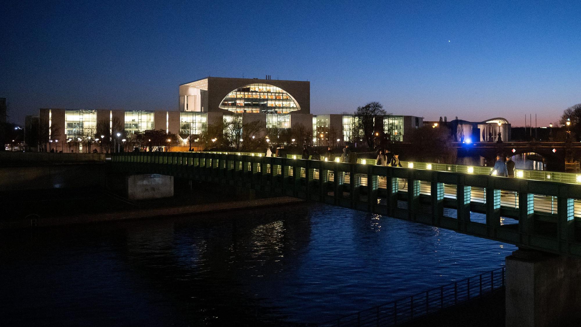 Hell erleuchtet ist das Kanzleramt hinter der Gustav-Heinemann-Brücke.