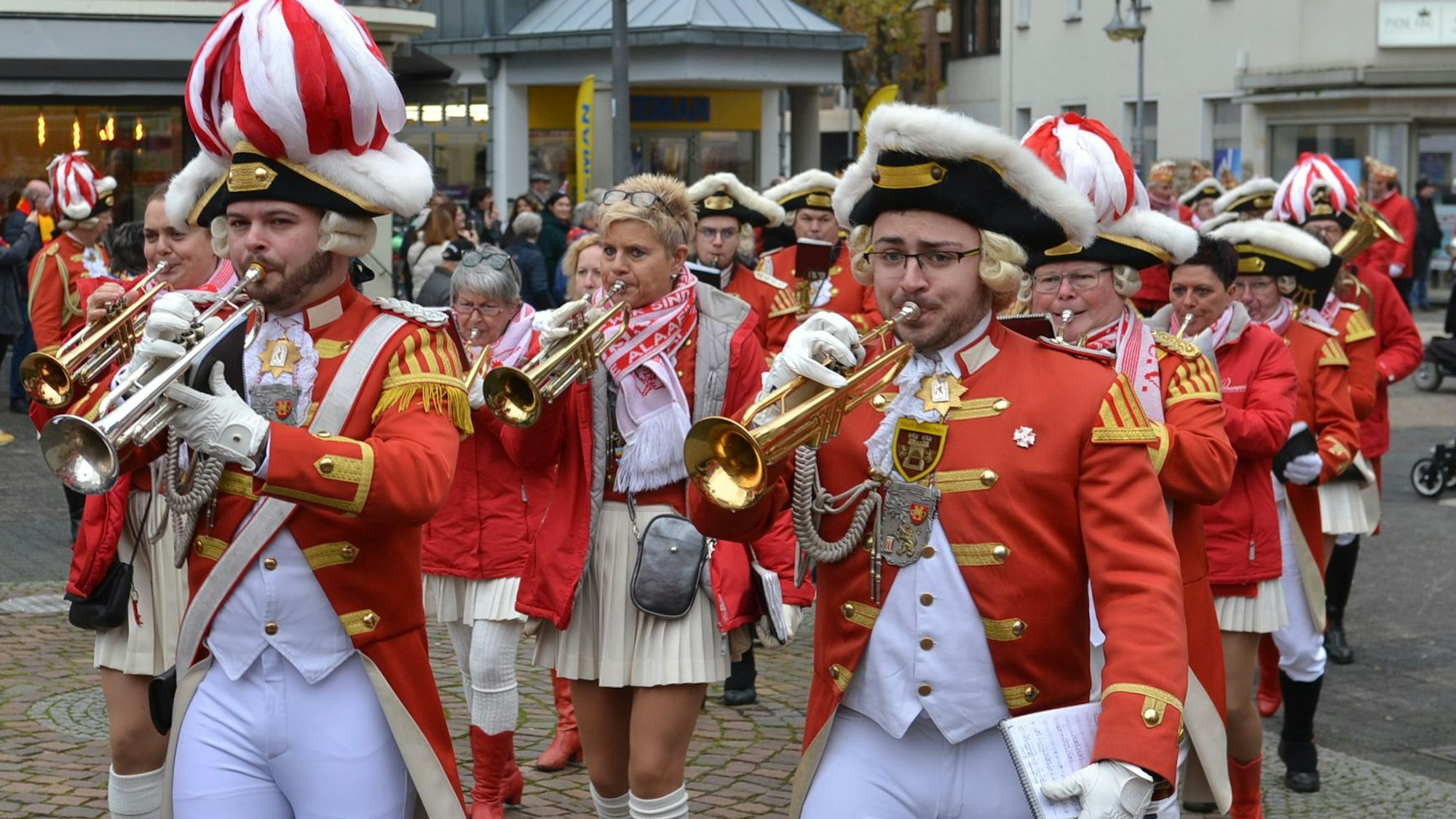 Der rot-weiß uniformierte Musikzug der Prinzengarde marschiert mit klingendem Spiel durch die Innenstadt.