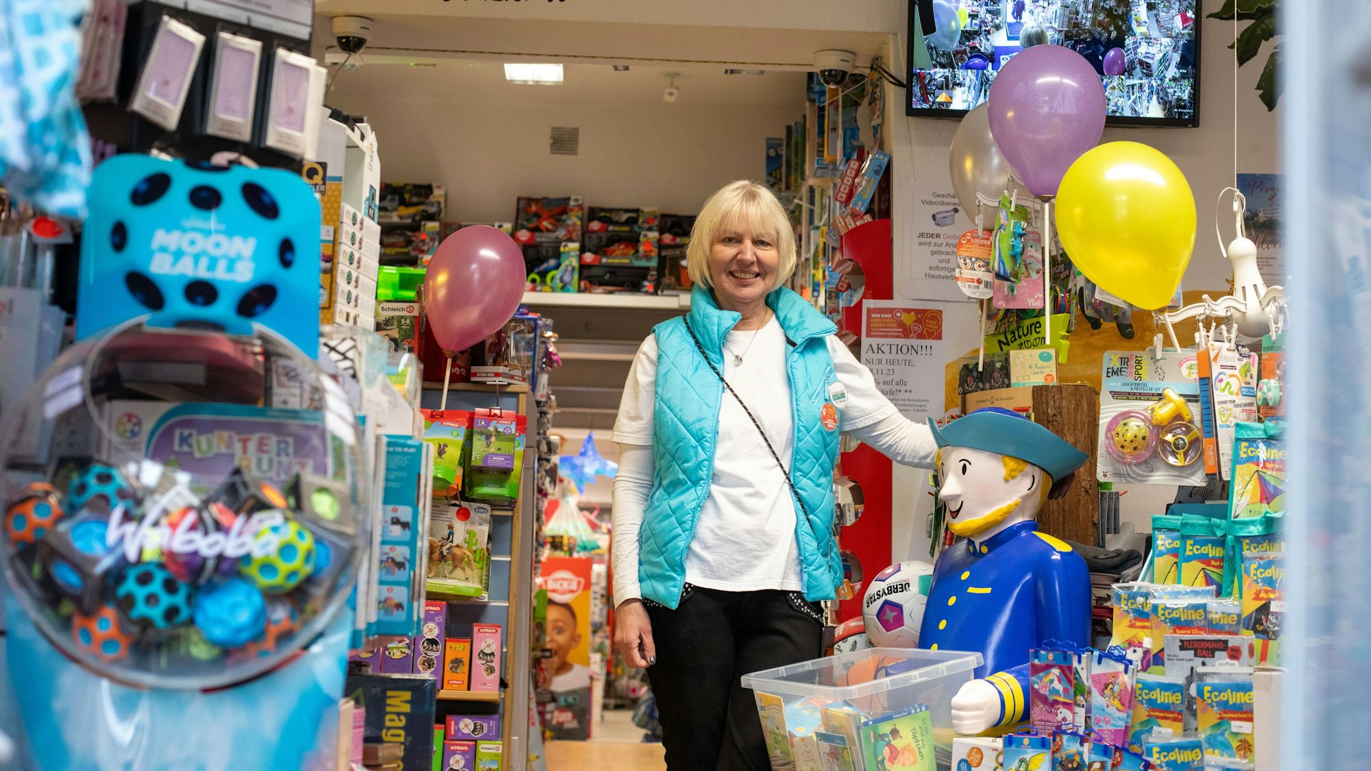 Eine Frau steht in Mitten von Spielzeug.