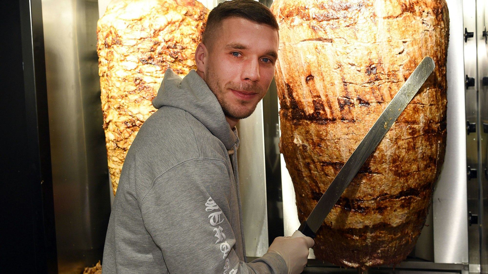 Fußball-Weltmeister Lukas Podolski in einem seiner Döner-Läden.