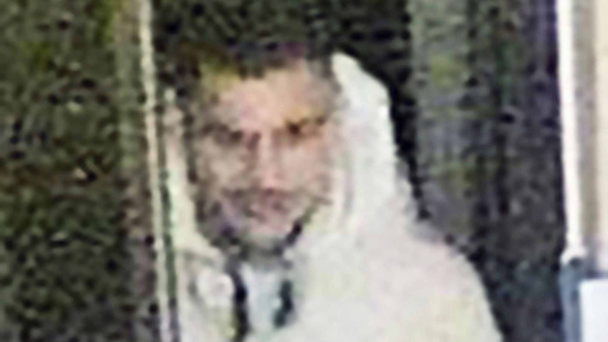 Ein Mann mit schwarzen Haaren und weißer Jacke