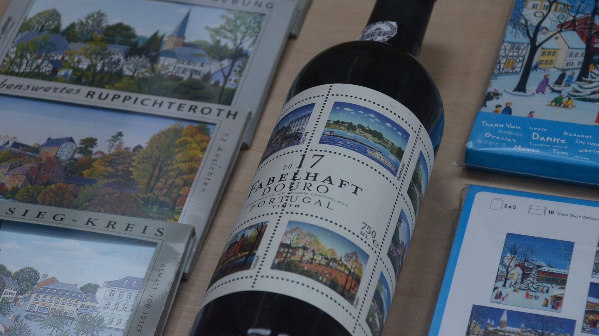 Grußkarten und eine Flasche Wein aus dem Douro-Tal in Portugal zeigen Illustrationen von Josef Hawle.