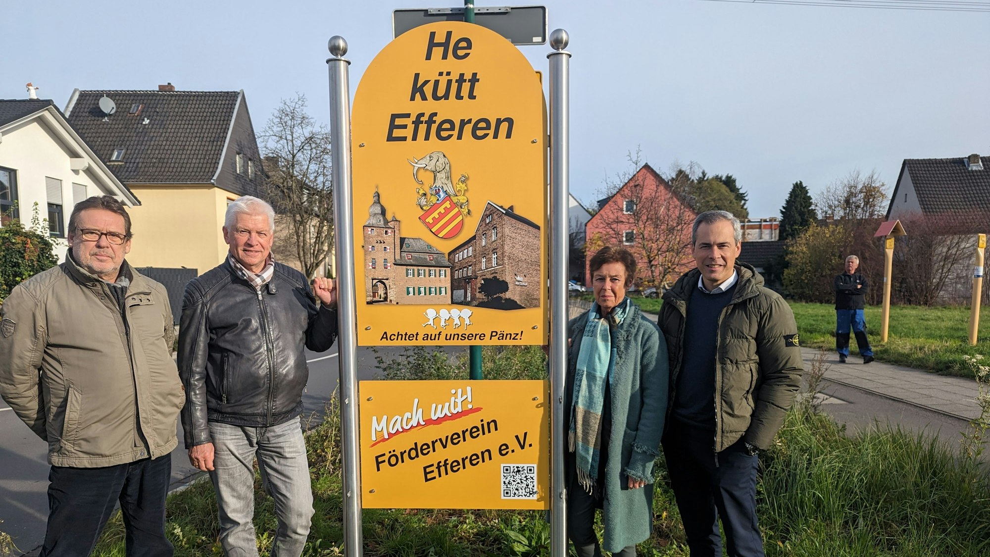Drei Männer und eine Frau neben einem der neuen Ortsschilder in Efferen.