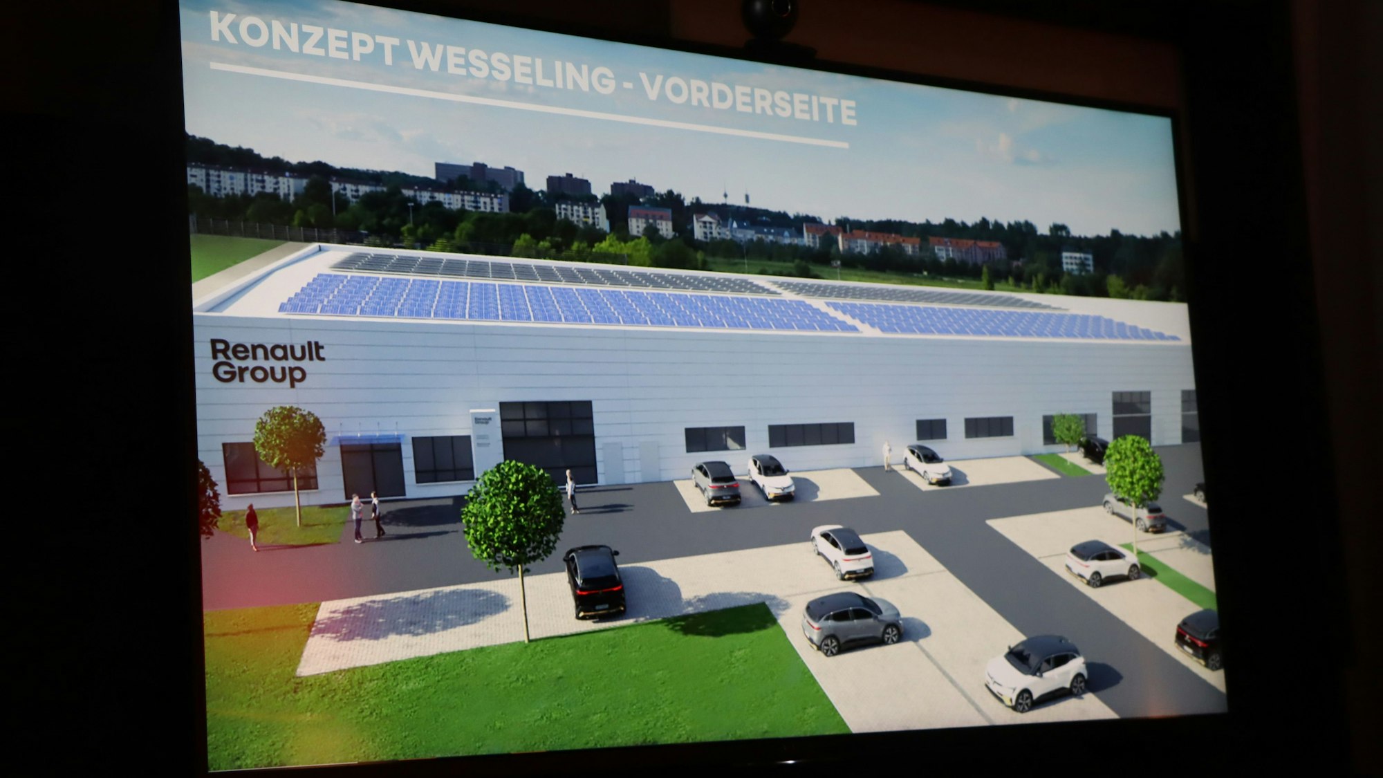 Auf dem Foto ist eine Animation zu sehen, die den Bau des Schulungszentrums zeigt.