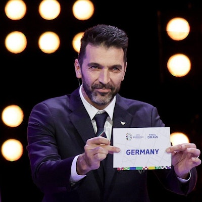 Der italienische Fußballtorwart und Weltmeister Gianluigi Buffon hält bei der Auslosung zur Fußball-Europameisterschaft 2024 einen Zettel hoch, auf dem Deutschland steht.