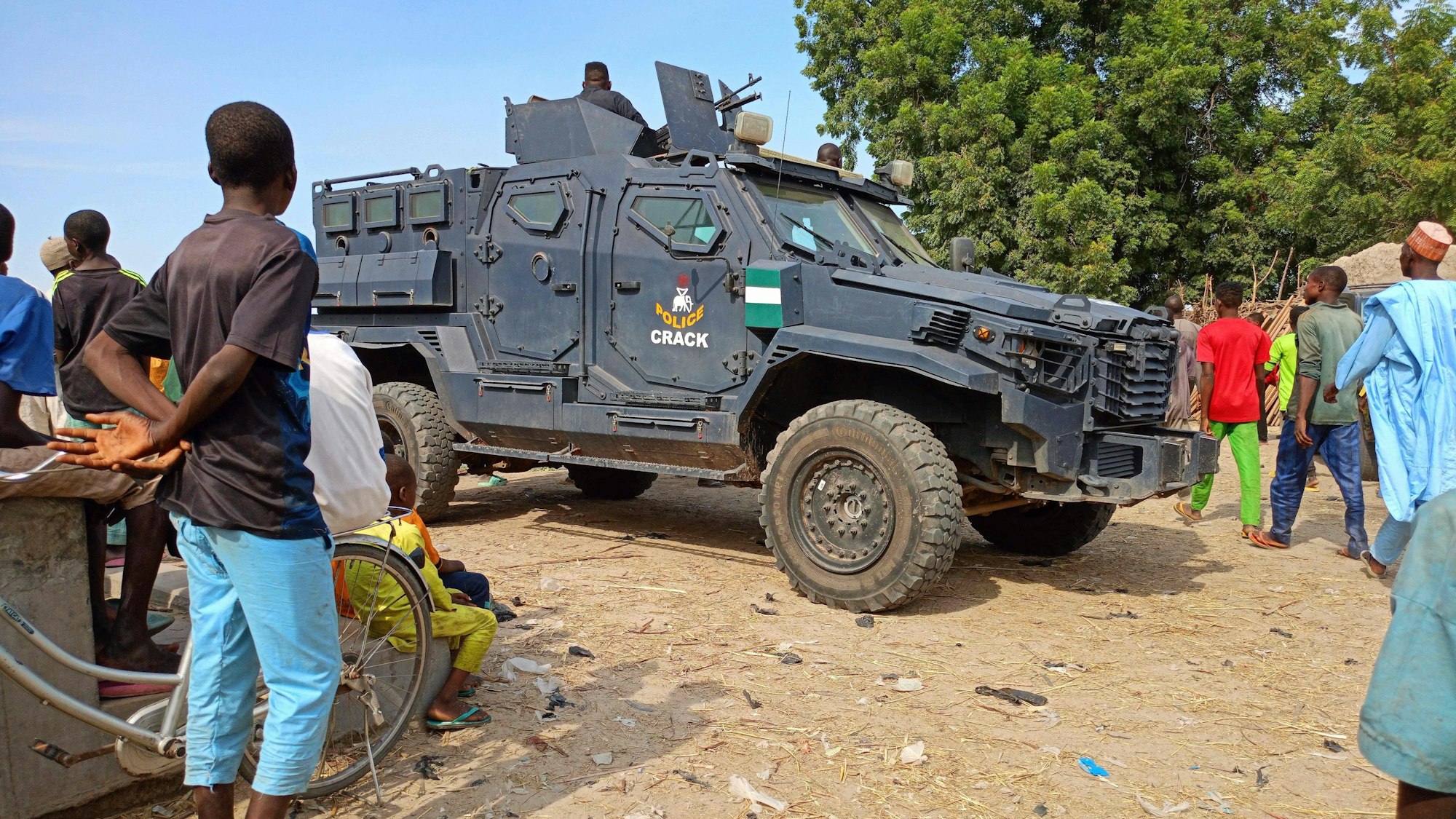 An armoured police vehicle is seen in the Zabarmari district, near Maiduguri, on November 6, 2023, during a burial of farmers that were victims of an attack. Jihadists have killed at least 11 farmers and several others are missing after an attack on rice fields in Nigeria's northeast Borno State, anti-jihadist militia and residents said on November 6, 2023.
Suspected Boko Haram jihadists stormed rice fields in Zabarmari district outside the regional capital Maiduguri late on November 5, 2023, seizing farmers and slitting their throats while abducting others, the sources told AFP.
Farmers are often targeted by Islamist militants waging a 14-year conflict in Nigeria's northeast, where 40,000 people have been killed and more than two million displaced since 2009. (Photo by Audu MARTE / AFP)