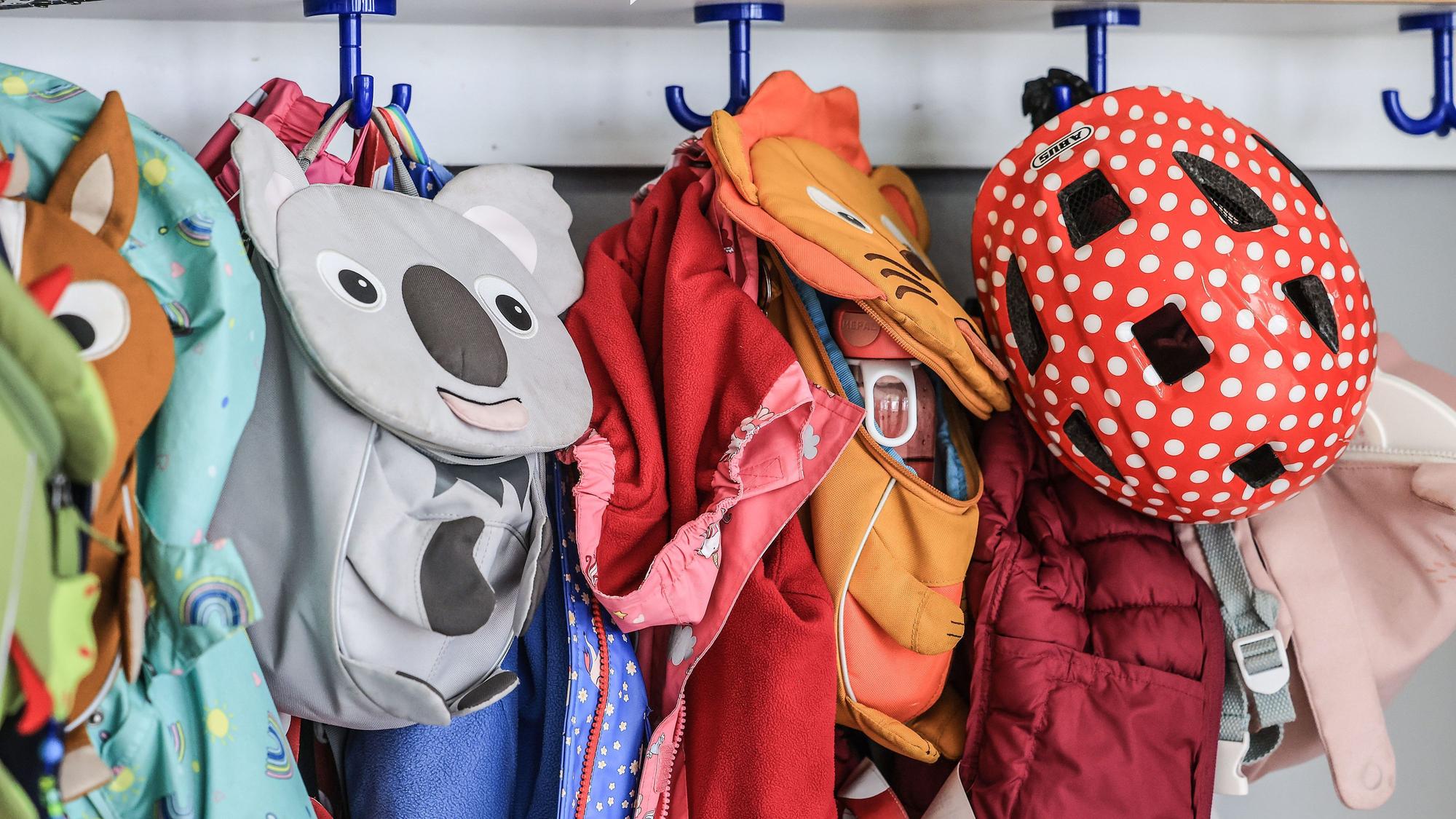 Garderobe und Taschen von Kindern hängen im Flur einer Kindertagesstätte.