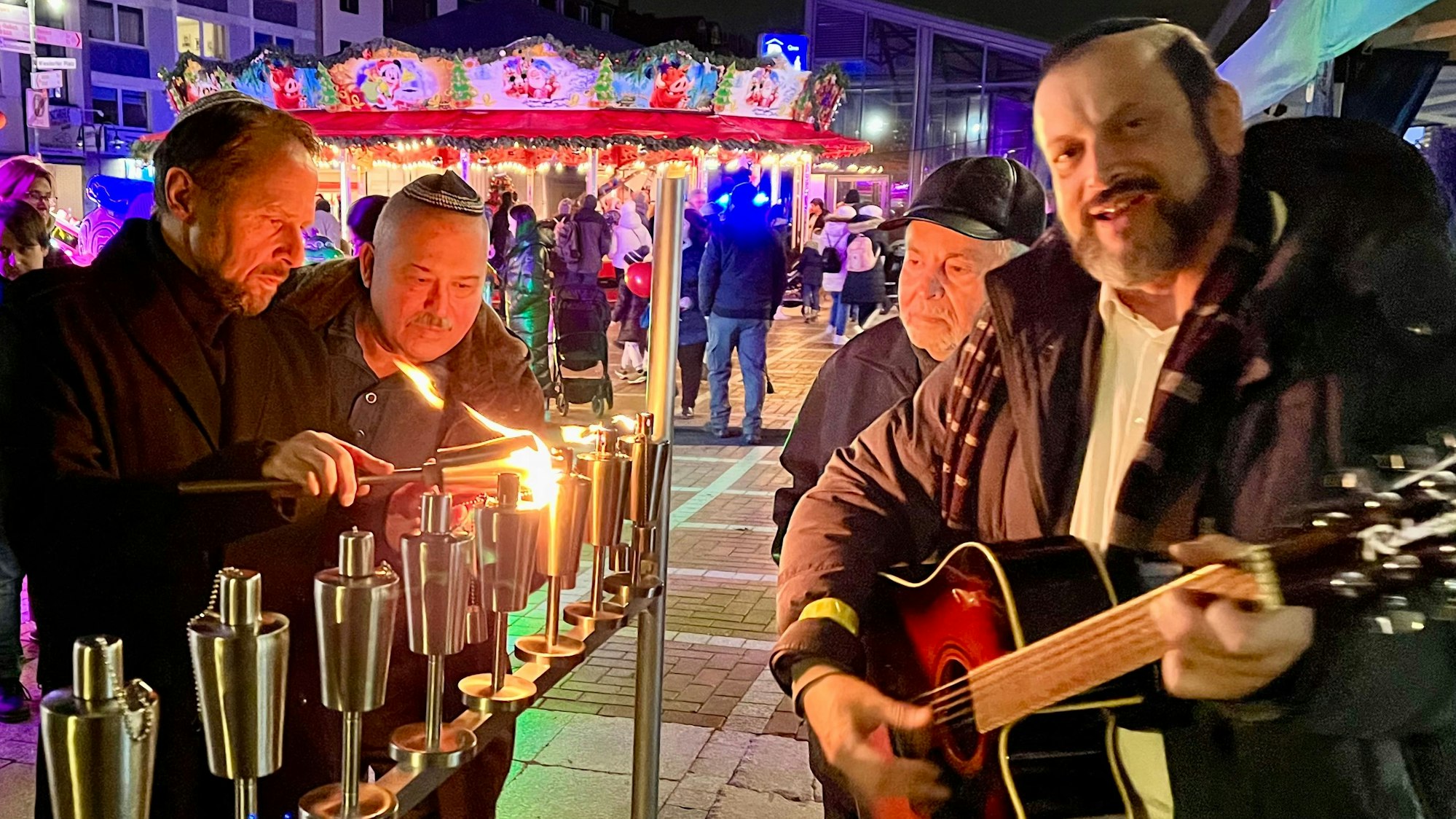 OB Uwe Richrath zündet den siebenarmigen Leuchter des jüdischen Kulturvereins Davidstern an.