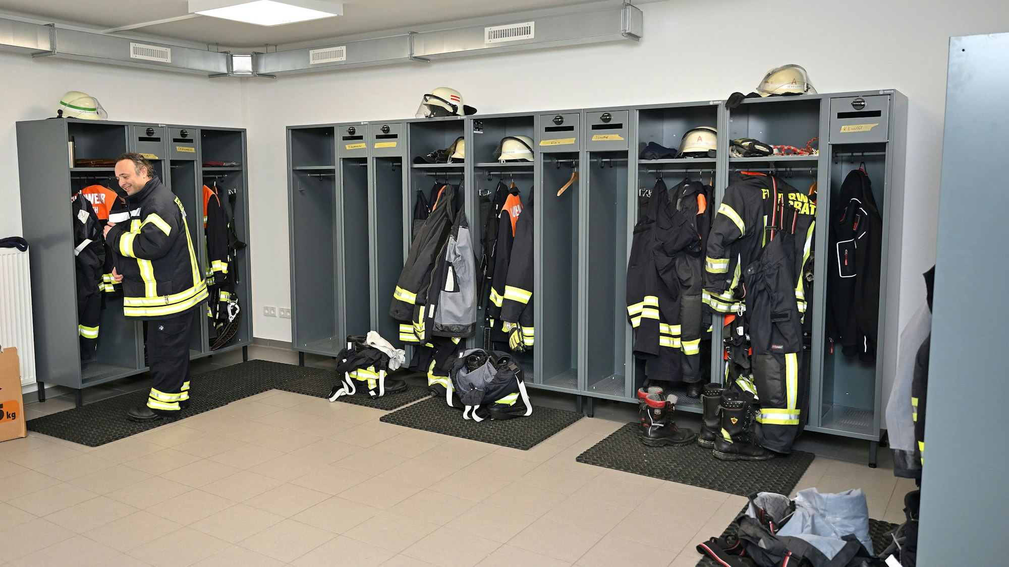 In Spinden von Feuerwehrleuten hängt Einsatzkleidung.