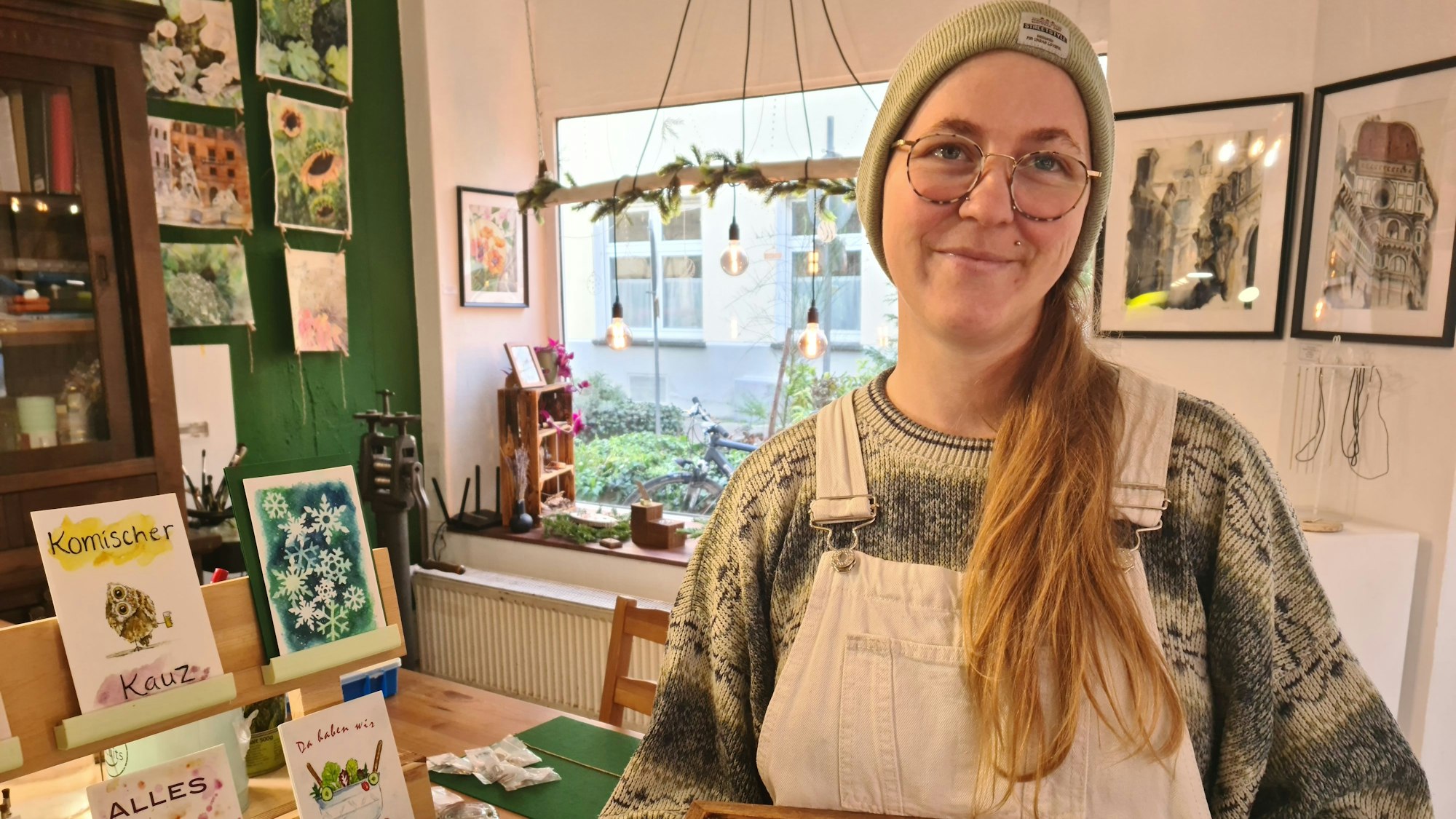 Schmuckdesignerin Caitlin Rose aus Vancouver in weitem Pulli und weißer Latzhose.