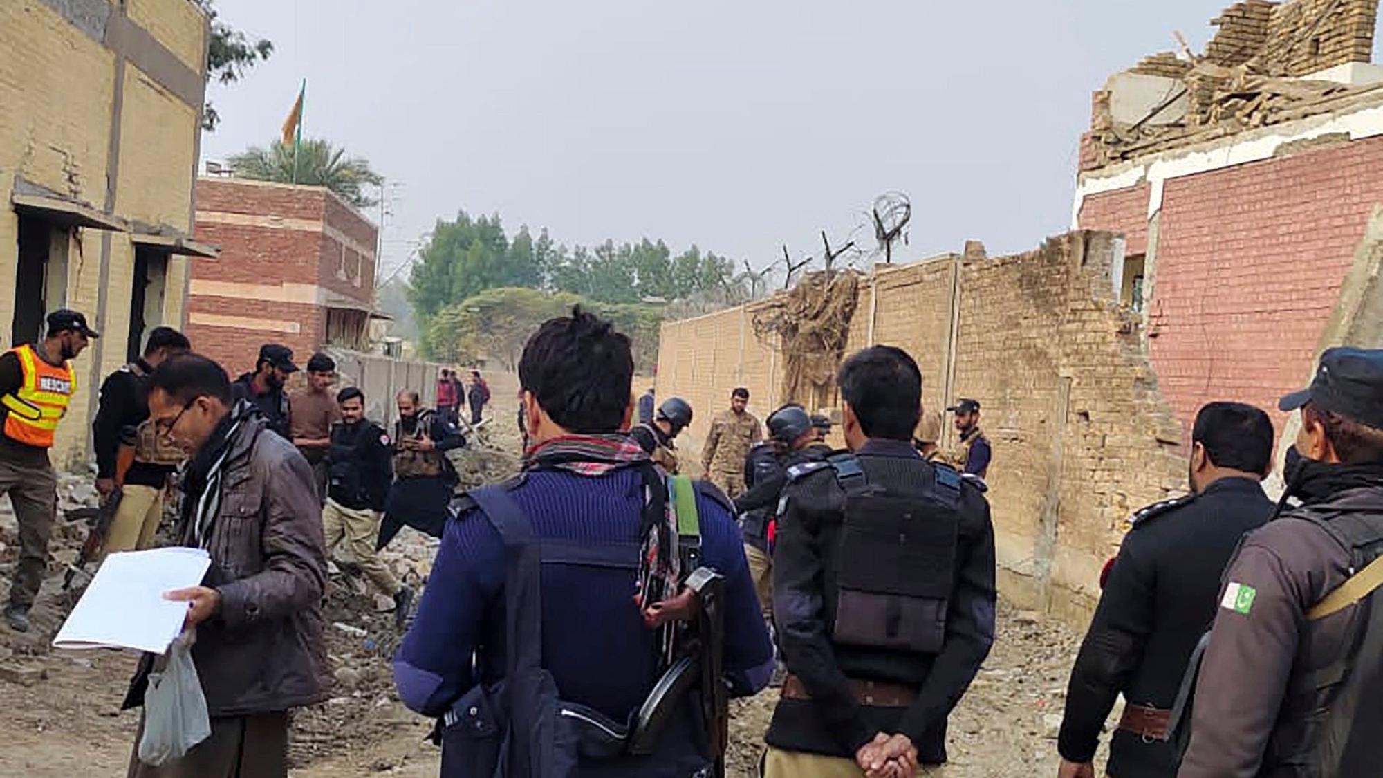 Security officials examine damages on the site of a bombing at a police station on the outskirts of Dera Ismail Khan, Pakistan, Tuesday, Dec. 12, 2023. A suicide bomber detonated his explosive-laden vehicle at a police station's main gate in northwest Pakistan on Tuesday, killing several policemen and wounding more than dozen others, officials said. Some militants also opened fire and a shootout between them and security forces was still ongoing, police officer Kamal Khan said. (AP Photo)