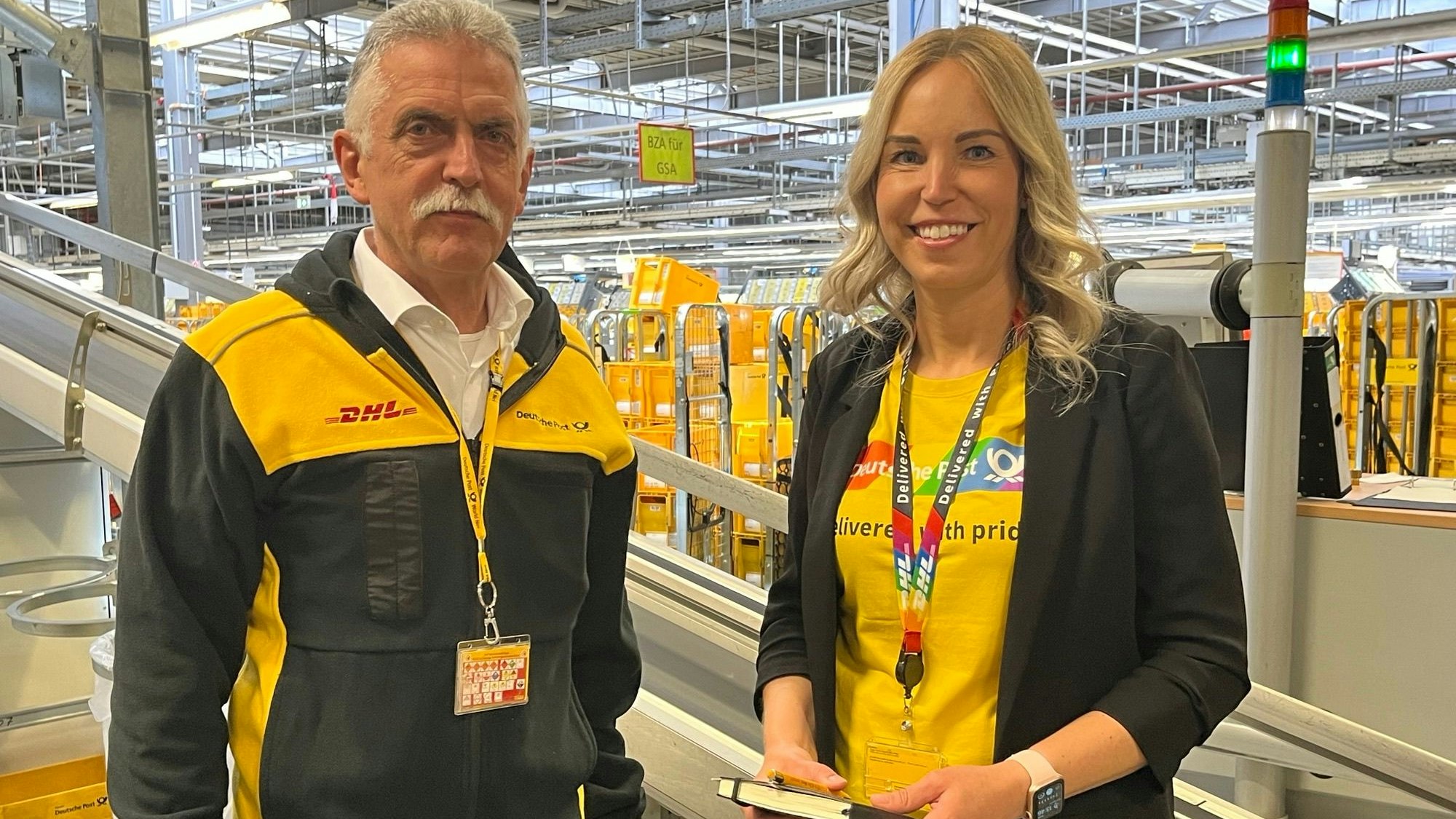 Auf dem Foto sind Andreas Crott und Katharina Putz von der DHL im Briefzentrum Frechen zu sehen.