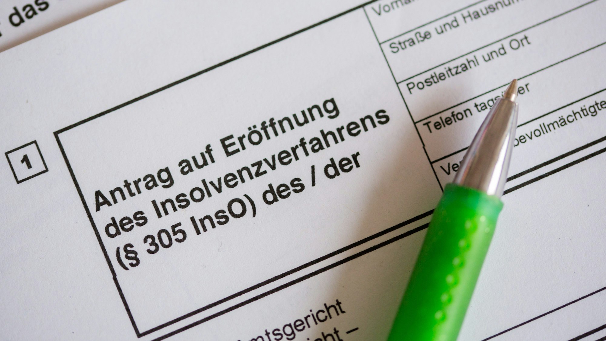 Das Bild zeigt ein Formular mit der Aufschrift „Antrag auf Eröffnung des Insolvenzverfahrens“