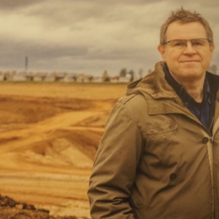 Ein Mann steht vor dem Krater.