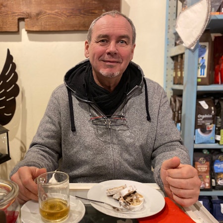 Ulrich Rüsenberg sitzt im weihnachtlich dekorierten Fair-Café in Zülpich.
