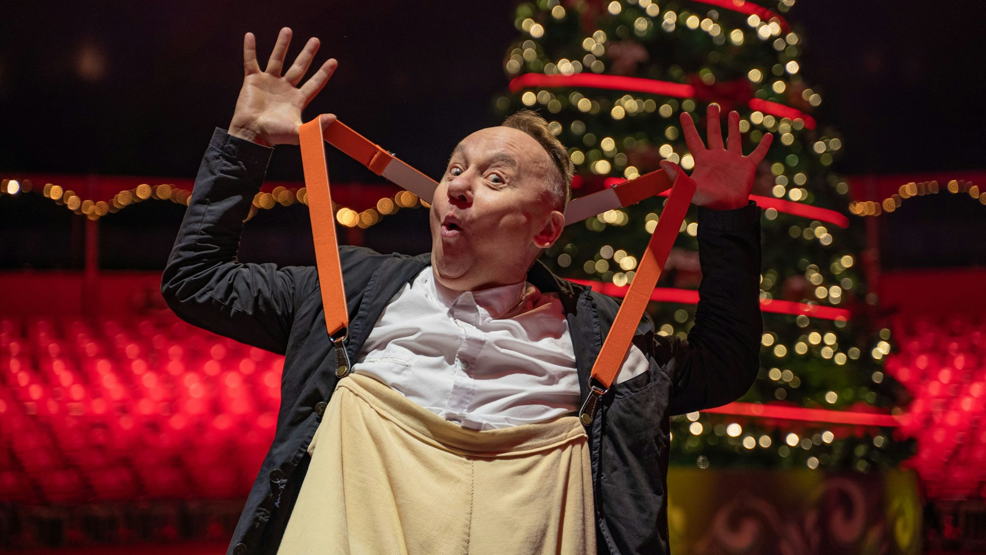 Andrey Jigalov posiert vor dem Weihnachtsbaum in der leeren Manege im Kölner Weihnachtscircus.