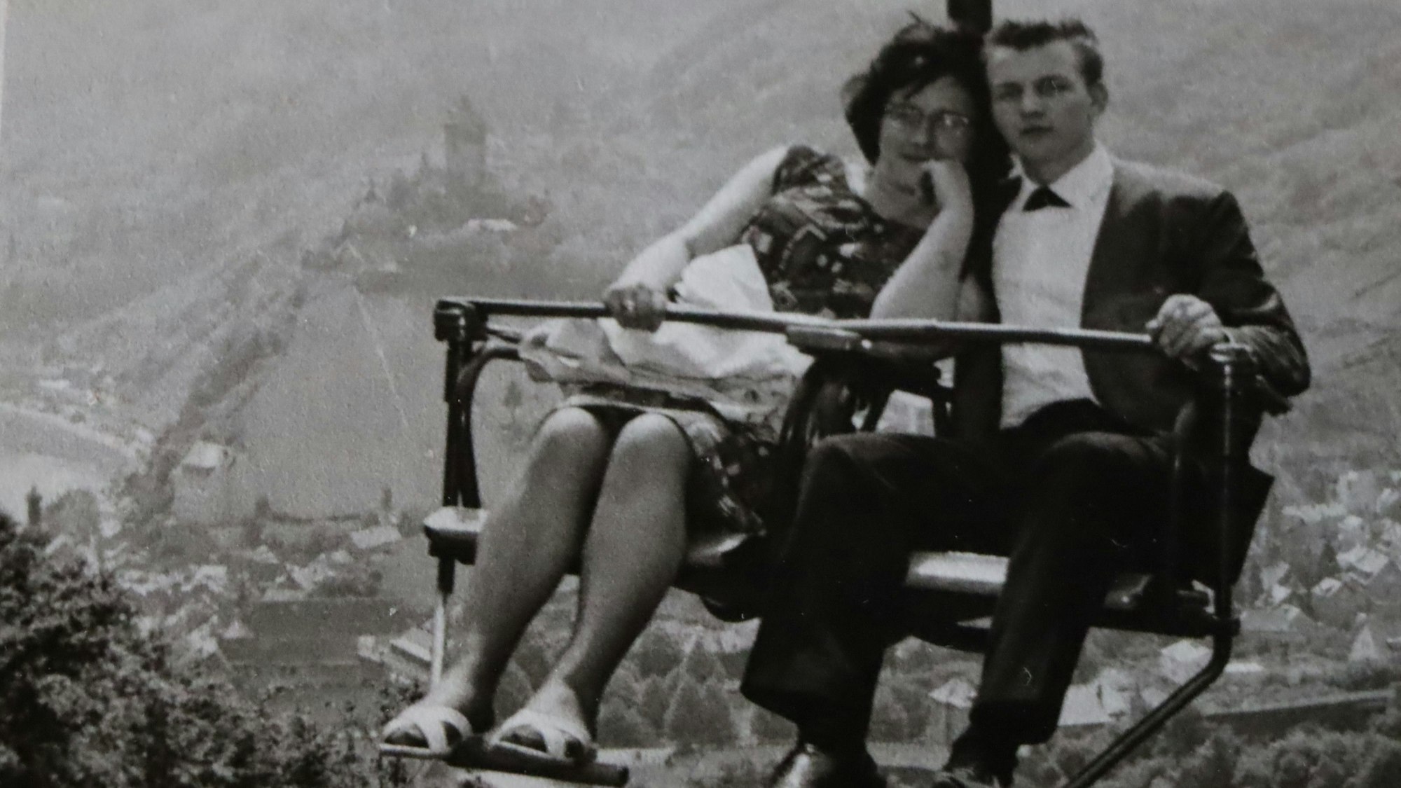 Ein Paar fährt mit einem Sessellift.