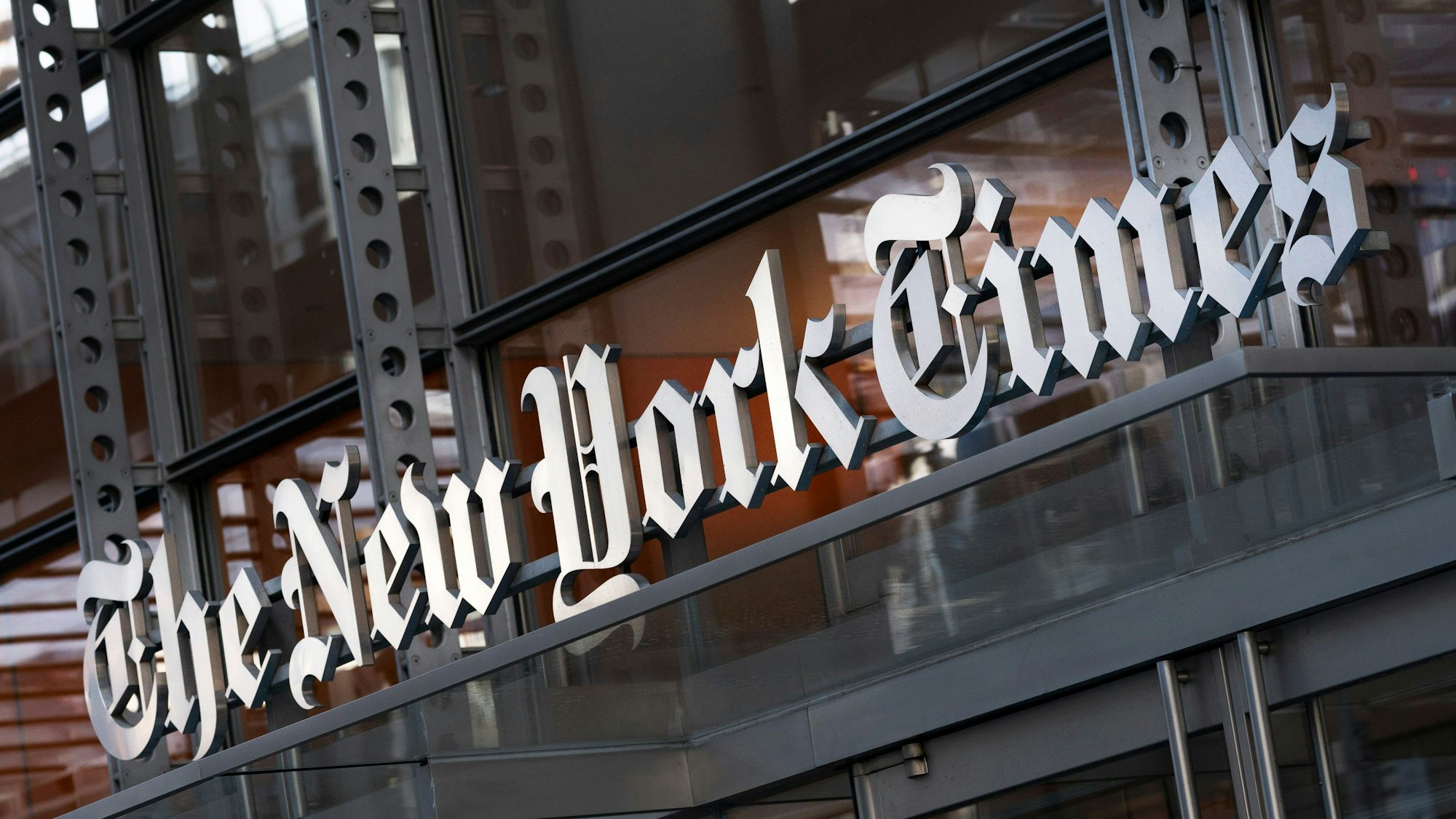 FILE - A sign for The New York Times hangs above the entrance to its building, Thursday, May 6, 2021 in New York. The New York Times filed a federal lawsuit against OpenAI and Microsoft on Wednesday, Dec. 27, 2023 seeking to end the practice of using published material to train chatbots. (AP Photo/Mark Lennihan, File)