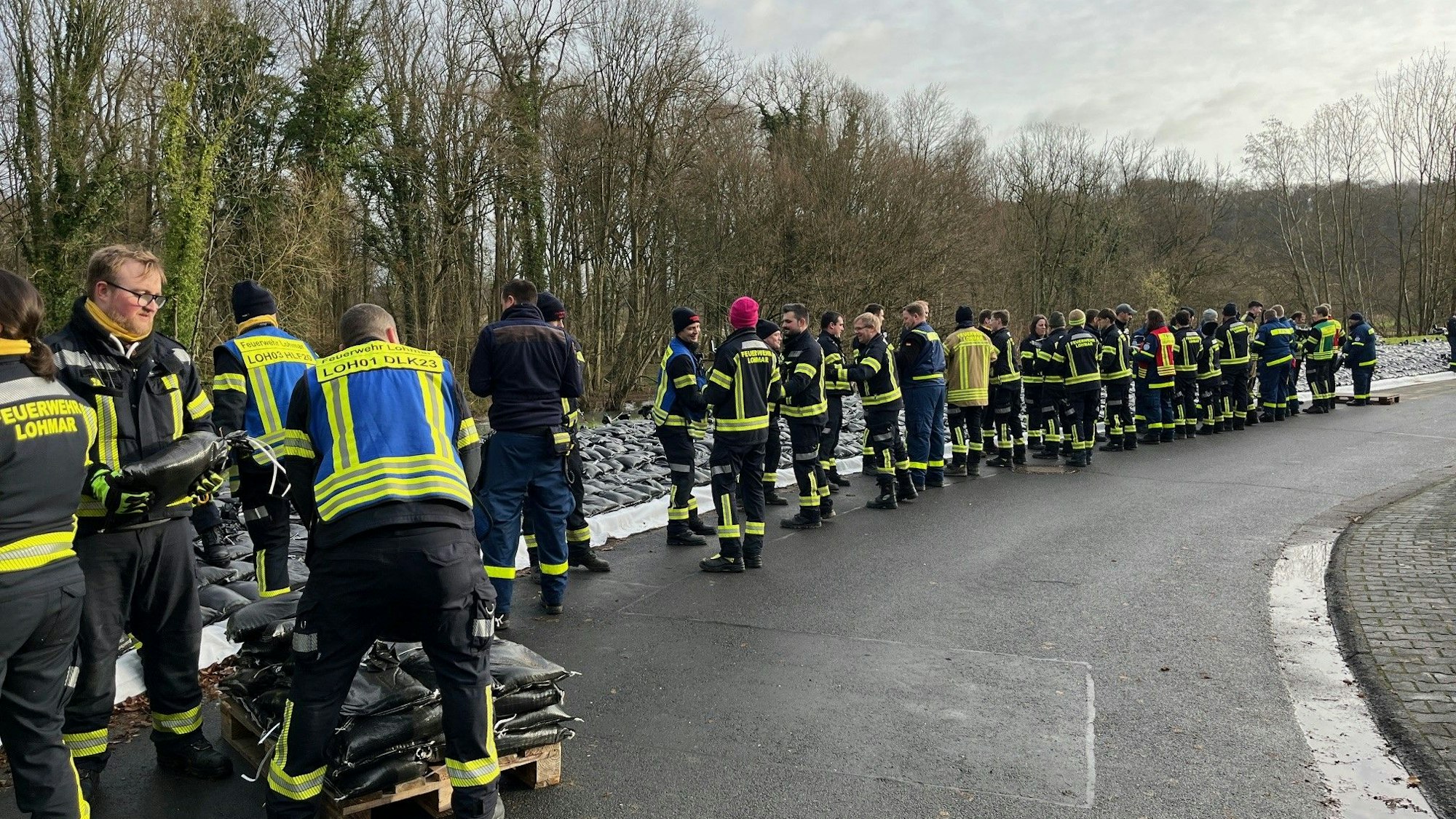 Einsatzkräfte verteilen Sandsäcke.