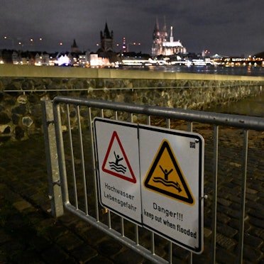 Hochwasser-Warnschilder sind am 27.12. am Rheinufer in Köln an einem Absperrgitter angebracht. Ergiebiger Dauerregen hatte den Pegelstand des Rheins ansteigen lassen, inzwischen ist er wieder deutlich gesunken. Doch es droht wieder Dauerregen.