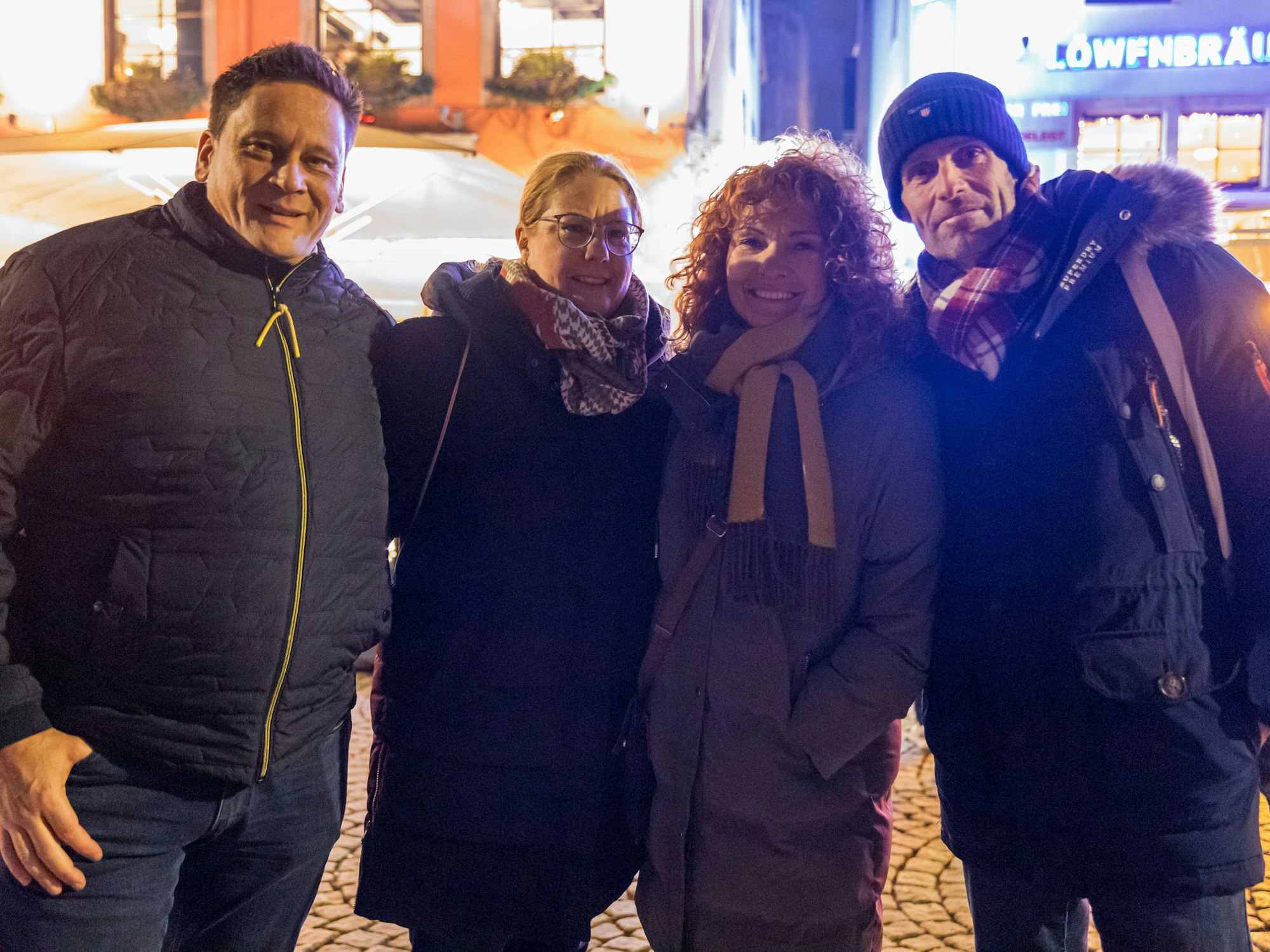 Vier Menschen lächeln in die Kamera