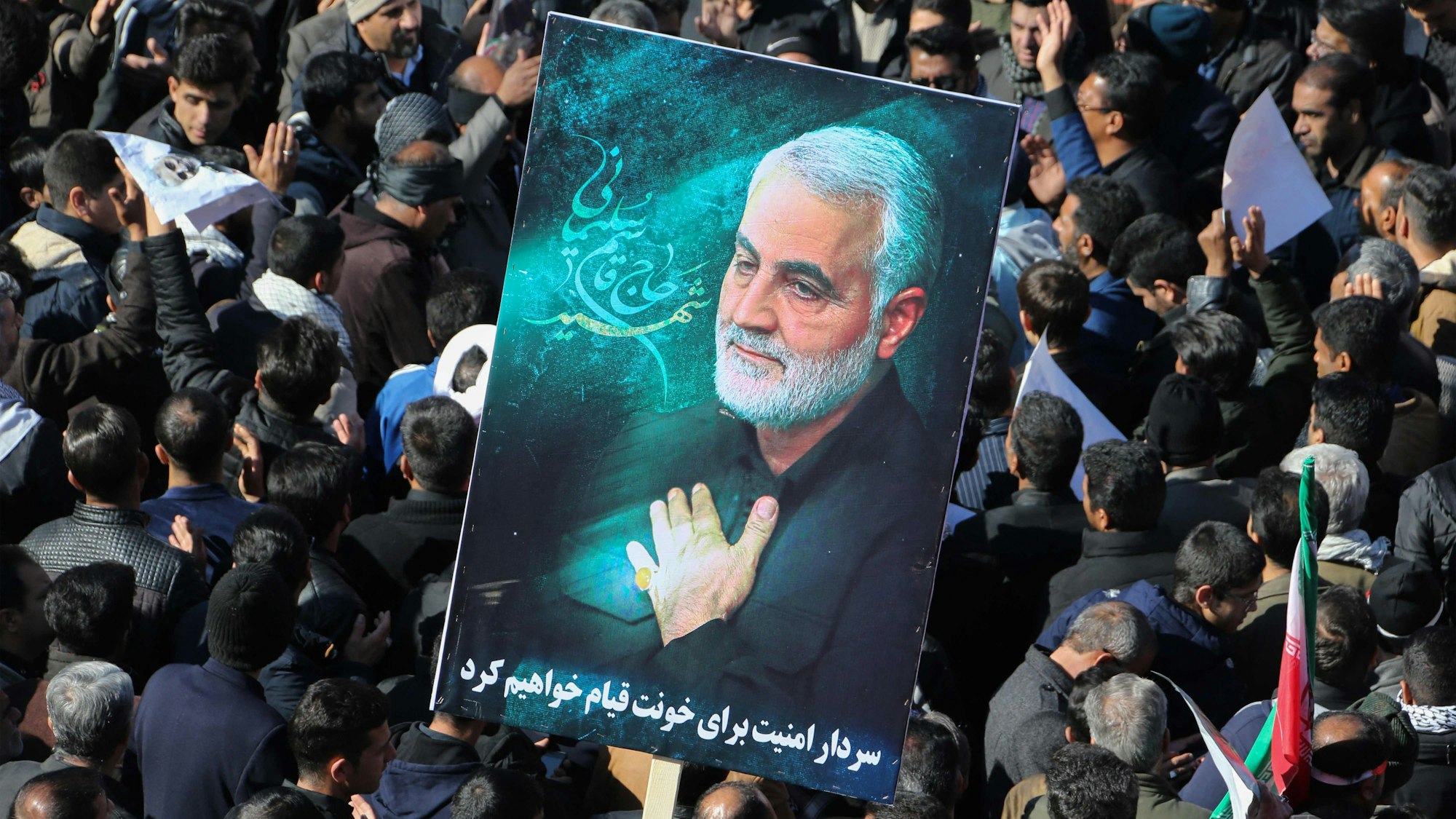 (FILES) Iranian mourners gather during the final stage of funeral processions for slain top general Qasem Soleimani, in his hometown Kerman on January 7, 2020. At least 20 people were killed in Iran on January 3, 2024 as two blasts struck a crowd marking the anniversary of the 2020 killing of general Qasem Soleimani, state television reported. Soleimani was killed outside Baghdad airport on January 3, 2020 in a drone strike ordered by then-US President Donald Trump. (Photo by ATTA KENARE / AFP)